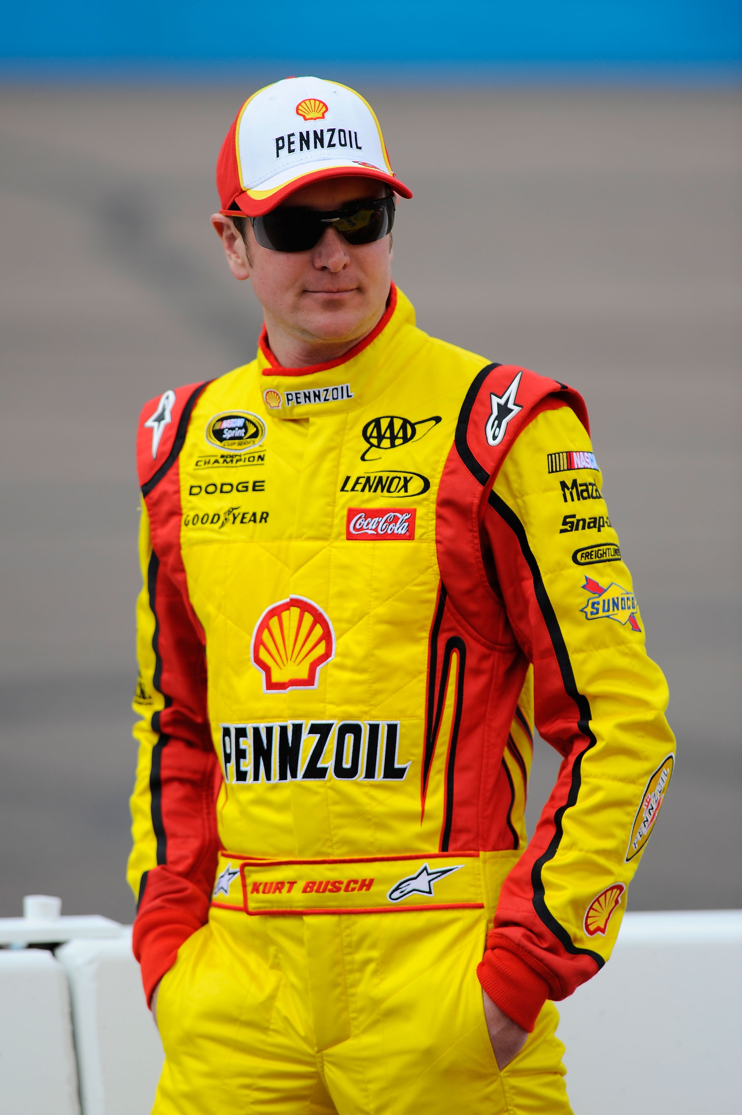 AVONDALE, AZ - FEBRUARY 26:  Kurt Busch, driver of the #22 Shell/Pennzoil Dodge, stands on pit road during qualifying for the NASCAR Sprint Cup Series Subway Fresh Fit 500 at Phoenix International Raceway on February 26, 2011 in Avondale, Arizona.  (Photo