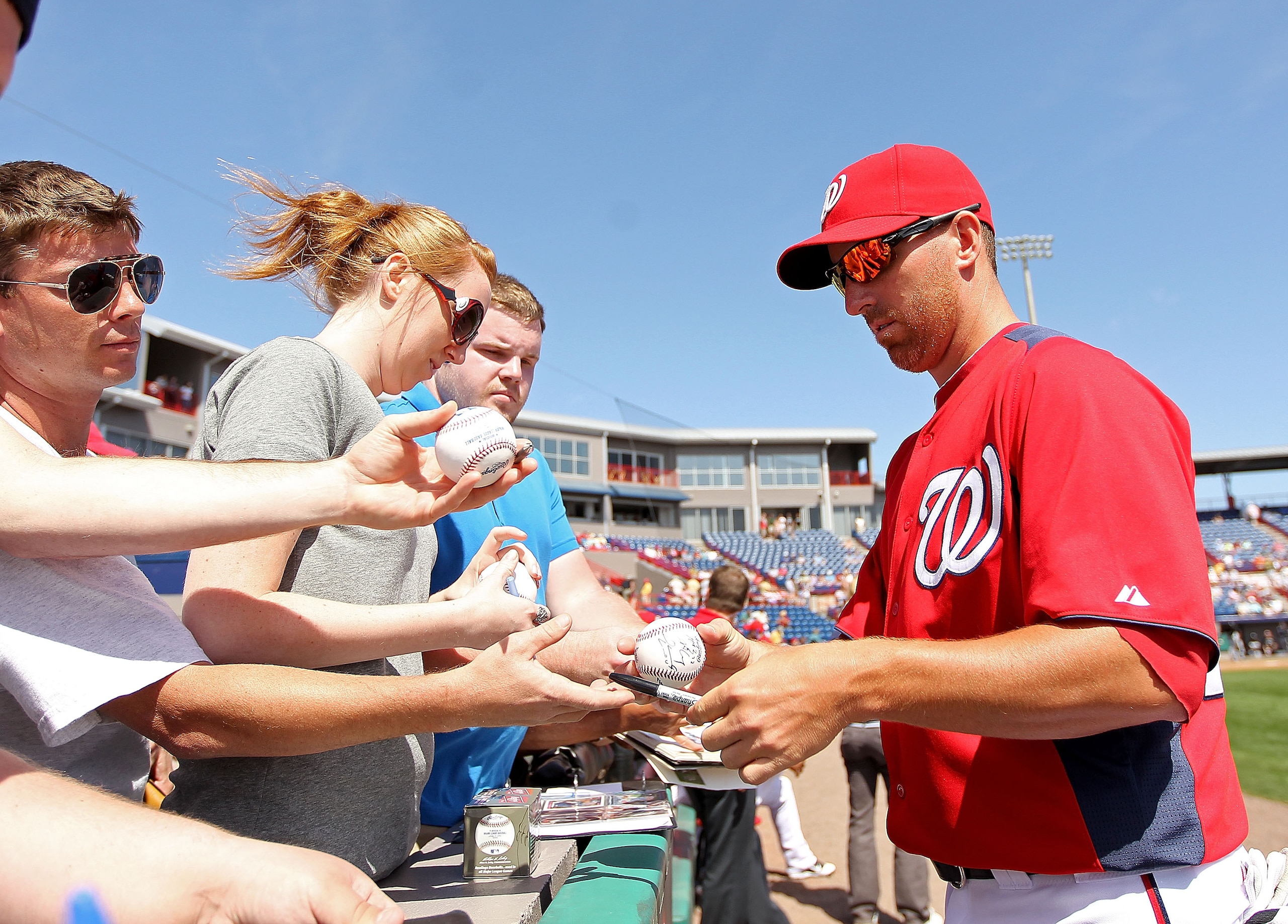 VIERA, FL - MARCH 02:  Adam LaRoche #25 of the Washington Nationals signs autographs during a Spring Training game against the Florida Marlins at Space Coast Stadium on March 2, 2011 in Viera, Florida.  (Photo by Mike Ehrmann/Getty Images)