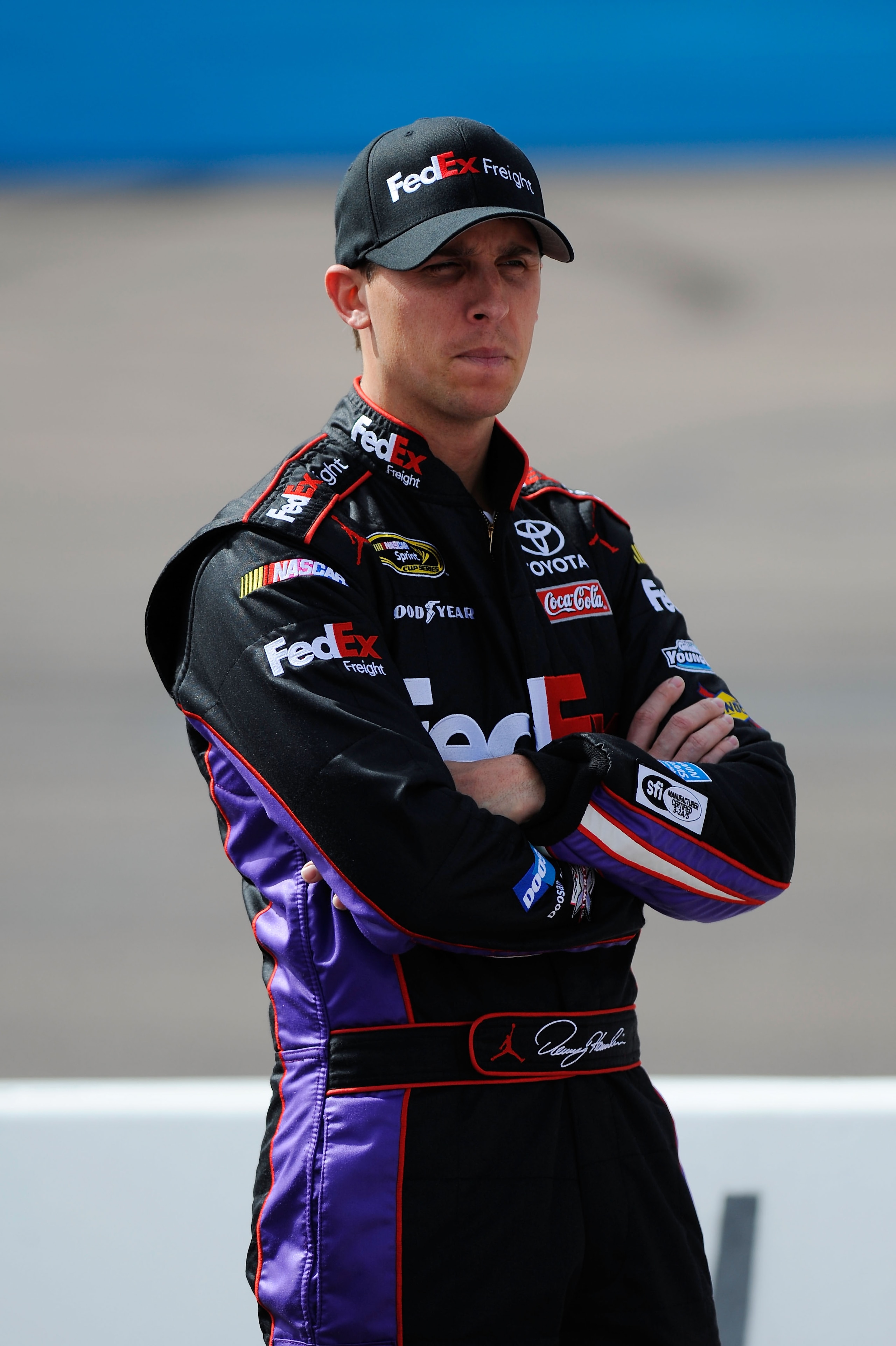 AVONDALE, AZ - FEBRUARY 26:  Denny Hamlin, driver of the #11 FedEx Toyota, stands on pit road during qualifying for the NASCAR Sprint Cup Series Subway Fresh Fit 500 at Phoenix International Raceway on February 26, 2011 in Avondale, Arizona.  (Photo by Ja