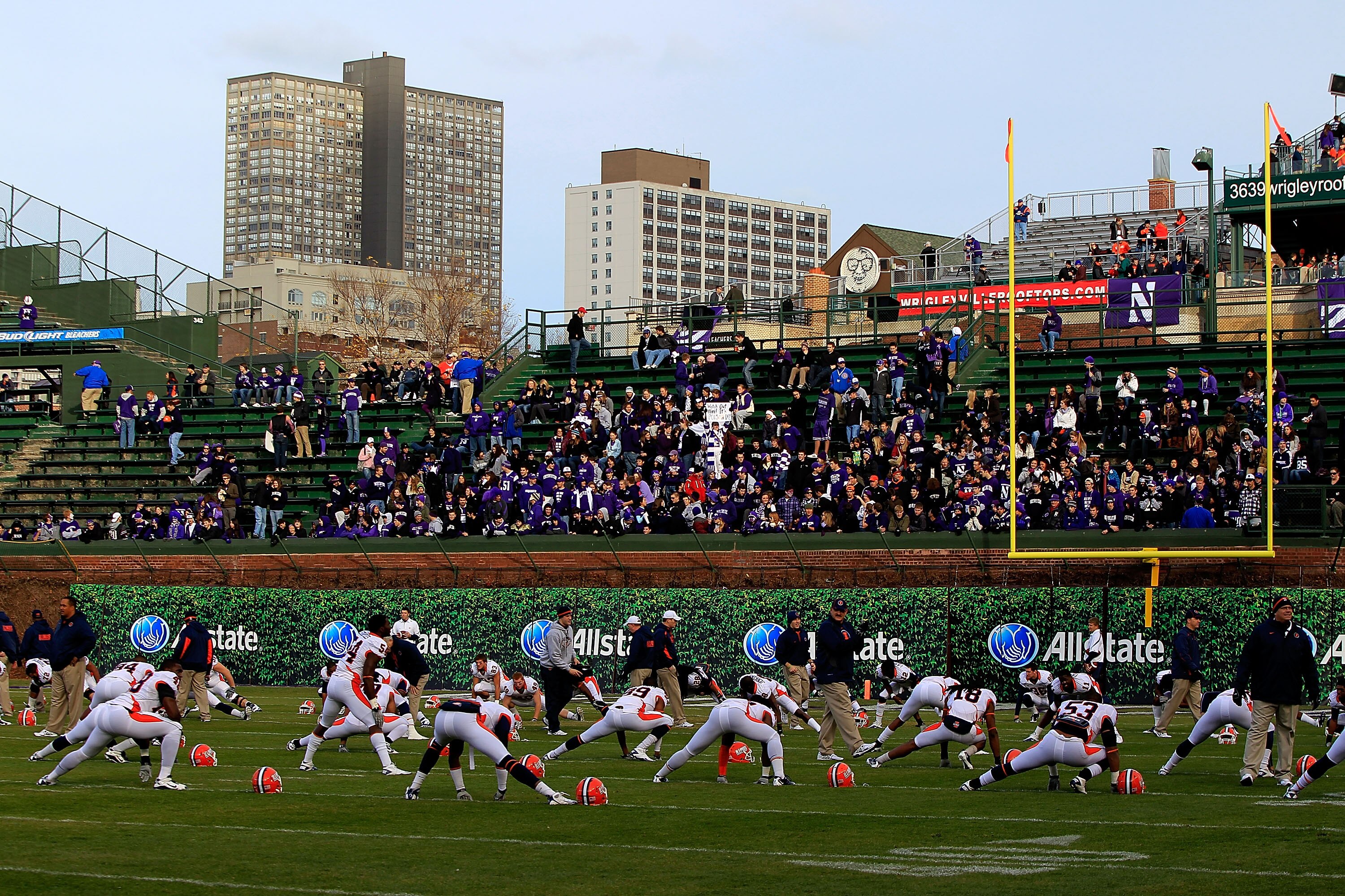CHICAGO - NOVEMBER 20: Members of the Illinois Fighting Illini stretch during warm-ups near the east end zone in right field that will not be used for a game against the Northwestern Wildcats due to player safety concerns at Wrigley Field on November 20,