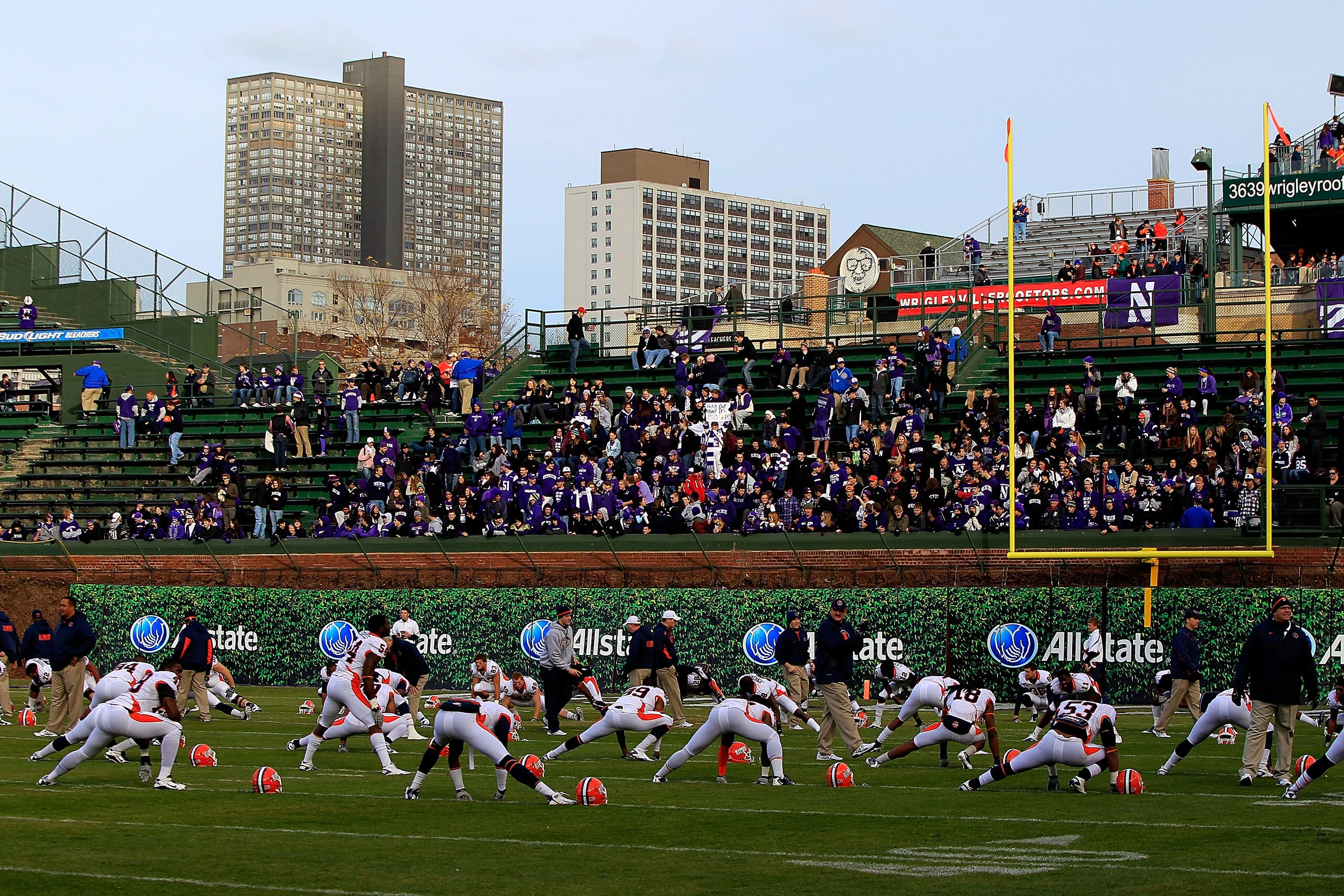 CHICAGO - NOVEMBER 20: Members of the Illinois Fighting Illini stretch during warm-ups near the east end zone in right field that will not be used for a game against the Northwestern Wildcats due to player safety concerns at Wrigley Field on November 20,
