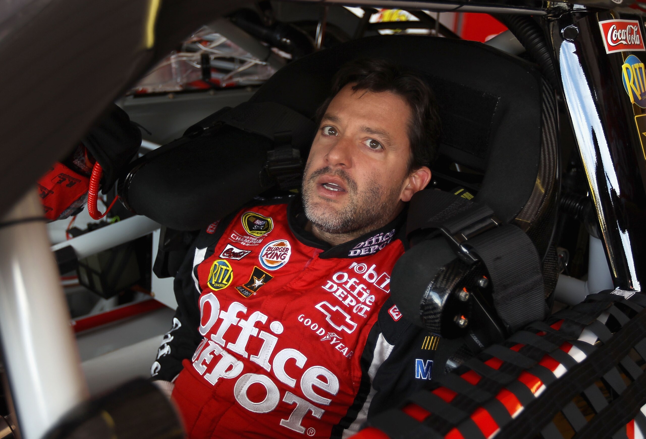 AVONDALE, AZ - FEBRUARY 25:  Tony Stewart, driver of the #14 Mobil 1/Office Depot Chevrolet, sits in his car during practice for the Subway Fresh Fit 500 at Phoenix International Raceway on February 25, 2011 in Avondale, Arizona.  (Photo by Christian Pete