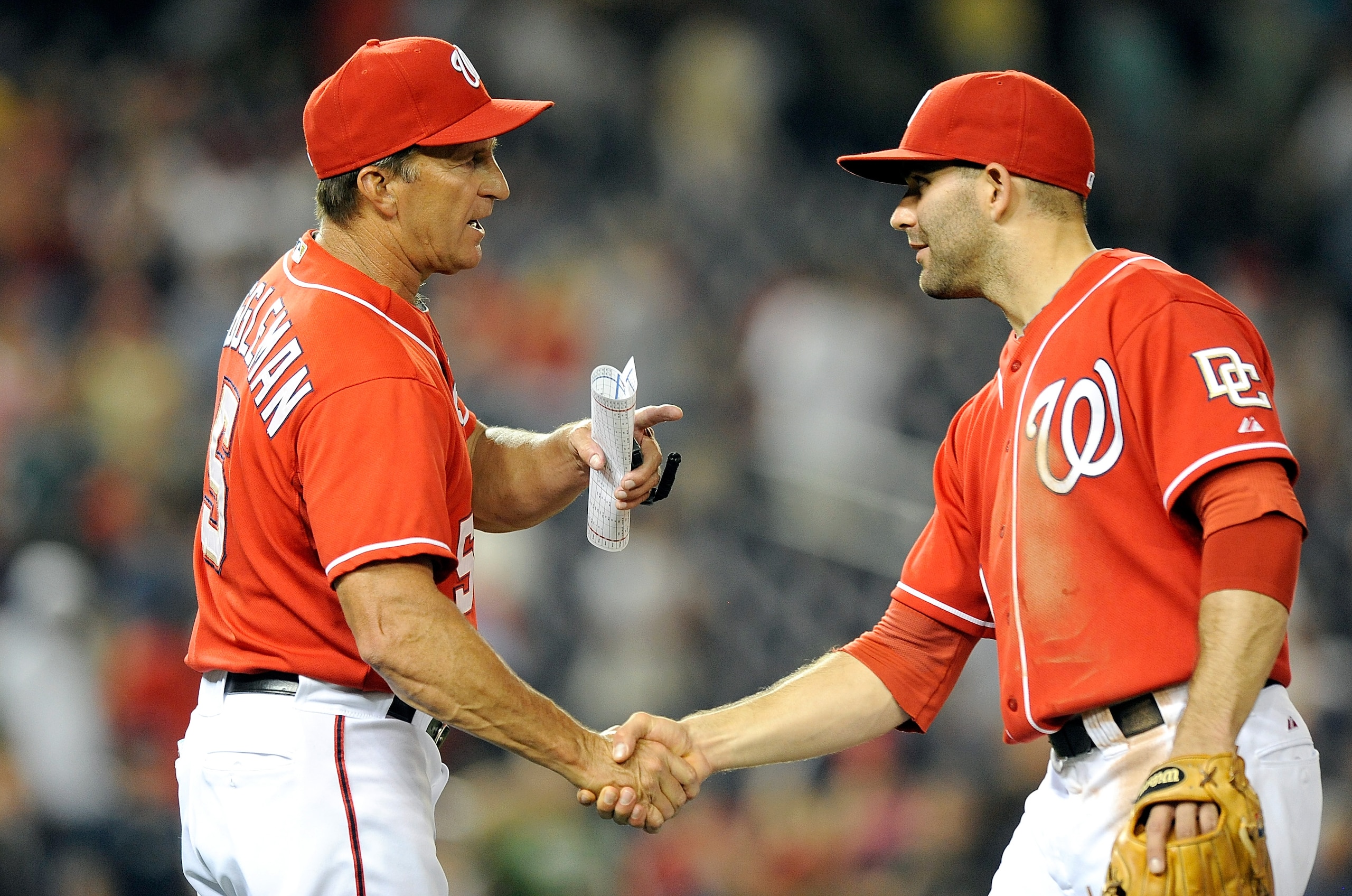 WASHINGTON - SEPTEMBER 24:  Manager  Jim Riggleman of the Washington Nationals celebrate with Danny Espinosa #18 after a 8-3 victory against the Atlanta Braves at Nationals Park on September 24, 2010 in Washington, DC.  (Photo by Greg Fiume/Getty Images)