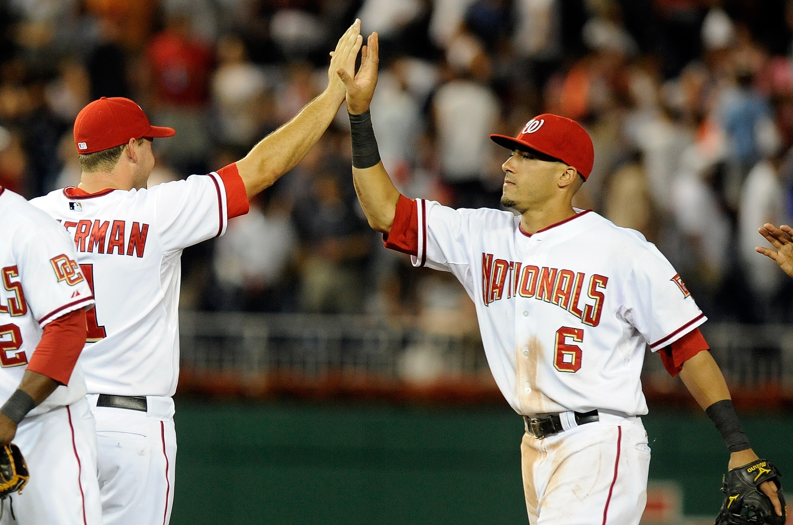 WASHINGTON - JULY 27:  Ian Desmond #6 and Ryan Zimmerman #11 of the Washington Nationals celebrate after a 3-0 victory against the Atlanta Braves at Nationals Park on July 27, 2010 in Washington, DC.  (Photo by Greg Fiume/Getty Images)