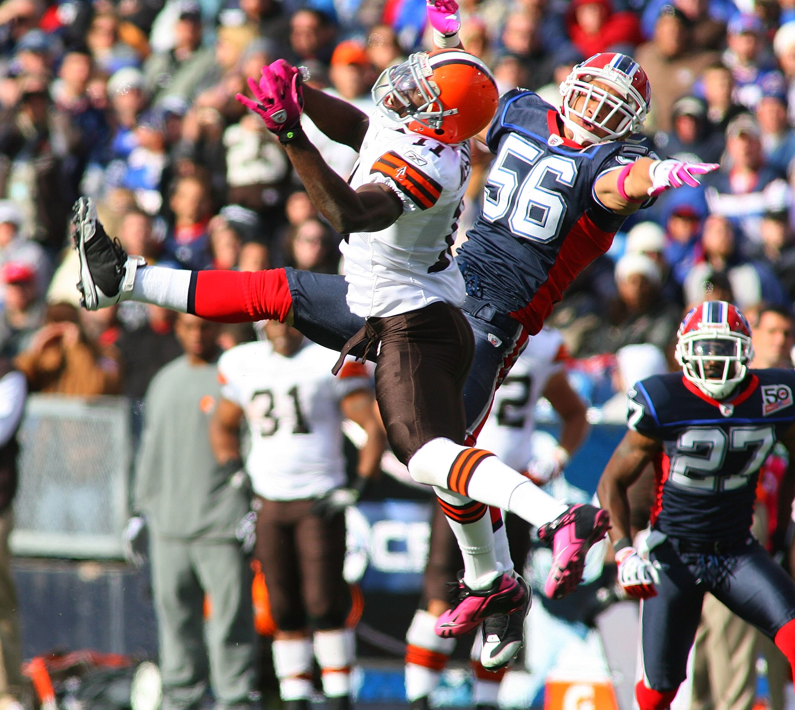 ORCHARD PARK, NY - OCTOBER 11: Mohammed Massaquoi #11 of the Cleveland Browns and Keith Ellison #56 of the Buffalo Bills try to make a play at Ralph Wilson Stadium on October 11, 2009 in Orchard Park, New York.  (Photo by Rick Stewart/Getty Images)