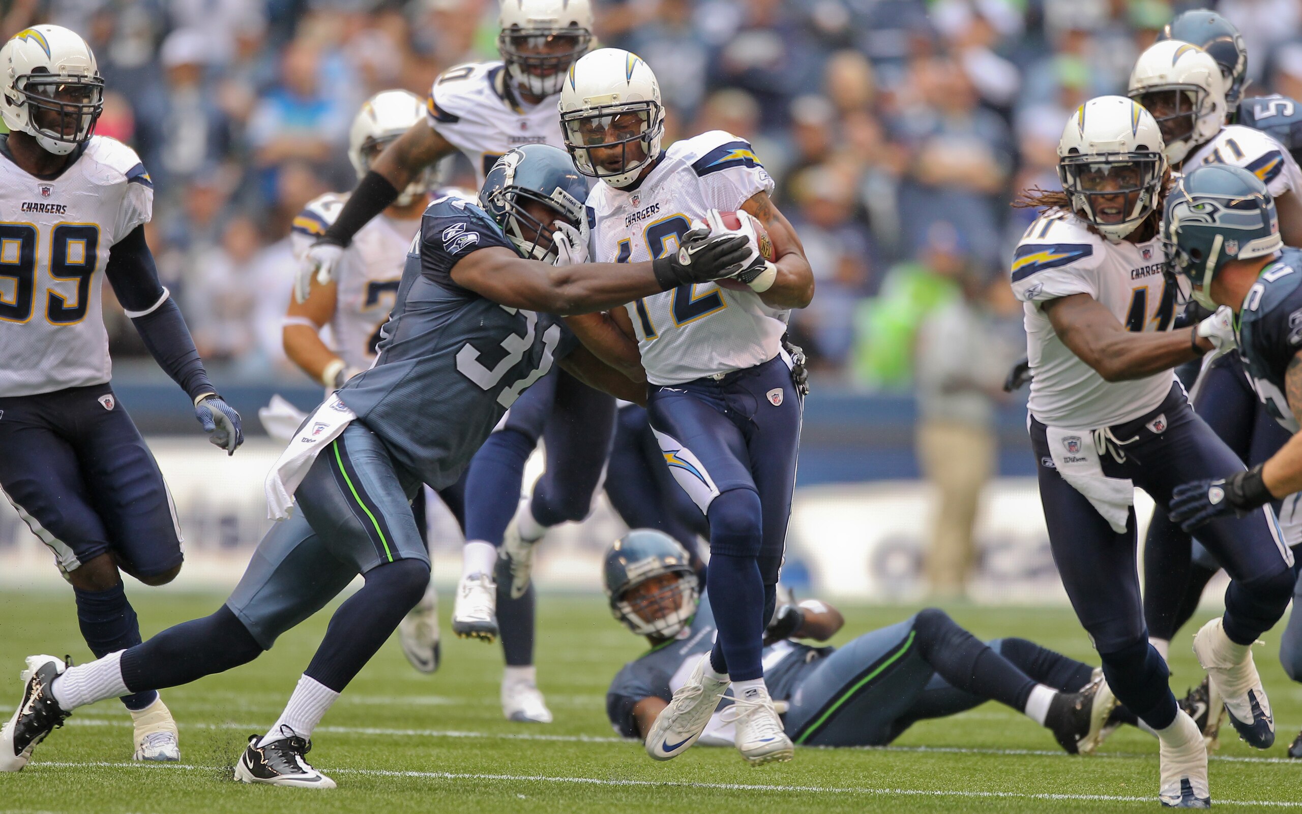 SEATTLE - SEPTEMBER 26:  Wide receiver Patrick Crayton #12 of the San Diego Chargers rushes against Kam Chancellor #31 of the Seattle Seahawks at Qwest Field on September 26, 2010 in Seattle, Washington. (Photo by Otto Greule Jr/Getty Images)