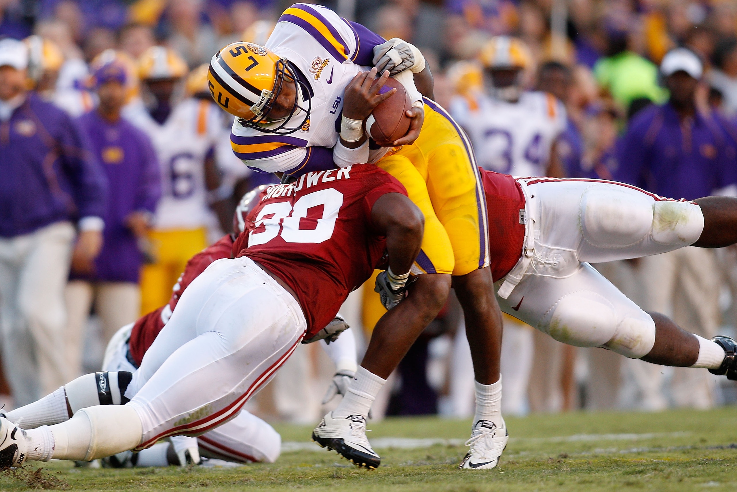 BATON ROUGE, LA - NOVEMBER 06:  Quarterback Jordan Jefferson #9 of the Louisiana State University Tigers is tackled by Dont'a Hightower #30 of the Alabama Crimson Tide at Tiger Stadium on November 6, 2010 in Baton Rouge, Louisiana. The Tigers defeated the