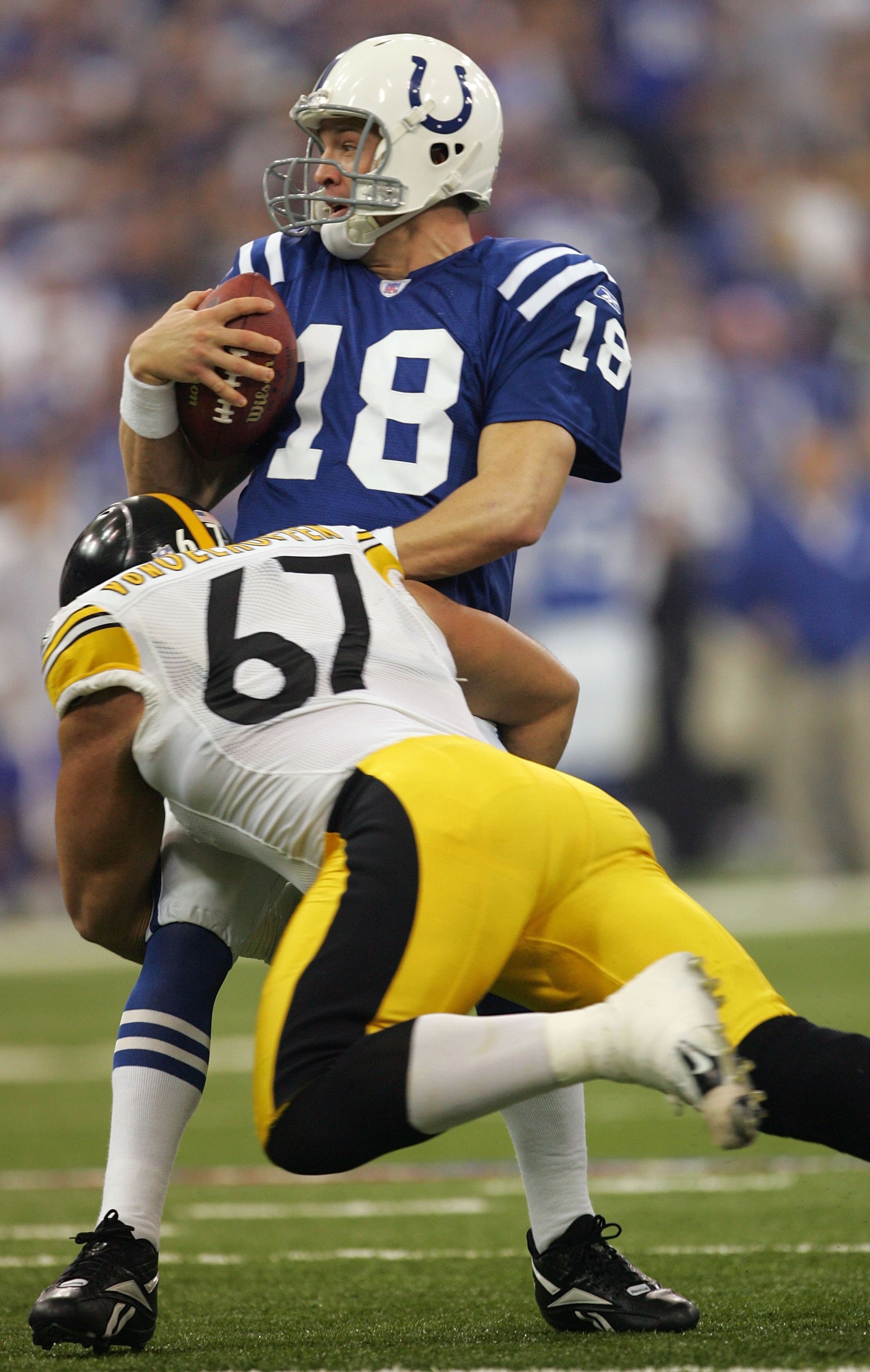 INDIANAPOLIS - JANUARY 15: Peyton Manning #18 of the Inidanapolis Colts is sacked by Kimo von Oelhoffen #67 the Pittsburgh Steelers during the AFC Divisional Playoffs January 15, 2006 at the RCA Dome in Indianapolis, Indiana. (Photo by Jamie Squire/Gett INDIANAPOLIS - JANUARY 15: Peyton Manning #18 of the Inidanapolis Colts is sacked by Kimo von Oelhoffen #67 the Pittsburgh Steelers during the AFC Divisional Playoffs January 15, 2006 at the RCA Dome in Indianapolis, Indiana. (Photo by Jamie Squire/Gett