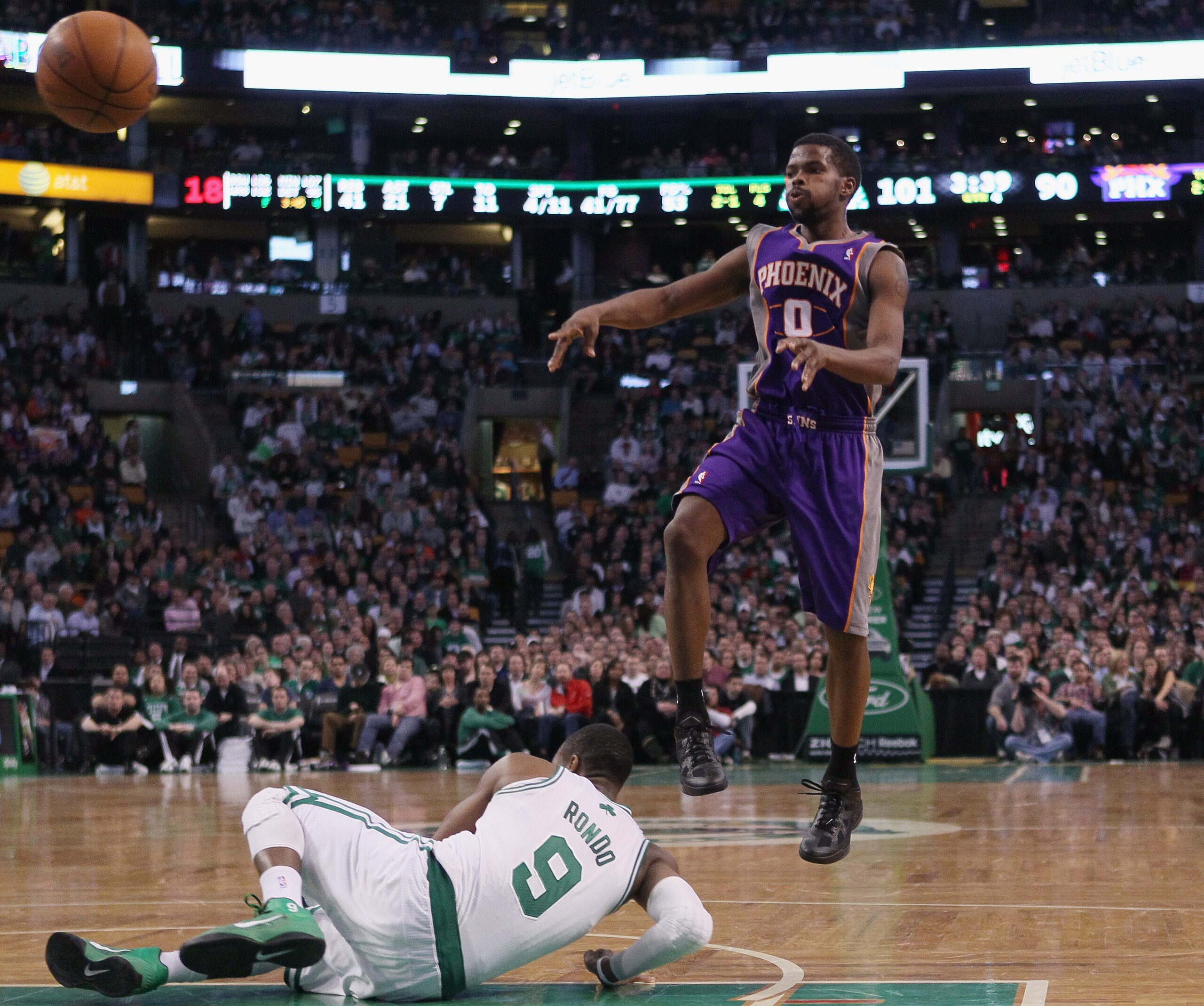 BOSTON, MA - MARCH 02:  Aaron Brooks #0 of the Phoenix Suns passes the ball over Rajon Rondo #9 of the Boston Celtics on March 2, 2011 at the TD Garden in Boston, Massachusetts.  The Celtics defeated the Suns 115-103. NOTE TO USER: User expressly acknowle