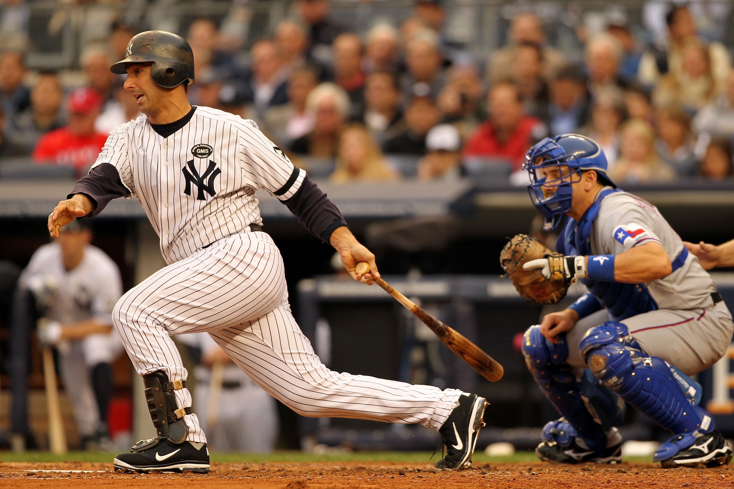 NEW YORK - OCTOBER 20:  Jorge Posada #20 of the New York Yankees hits a RBI single in the bottom of the second inning against the Texas Rangers in Game Five of the ALCS during the 2010 MLB Playoffs at Yankee Stadium on October 20, 2010 in the Bronx boroug