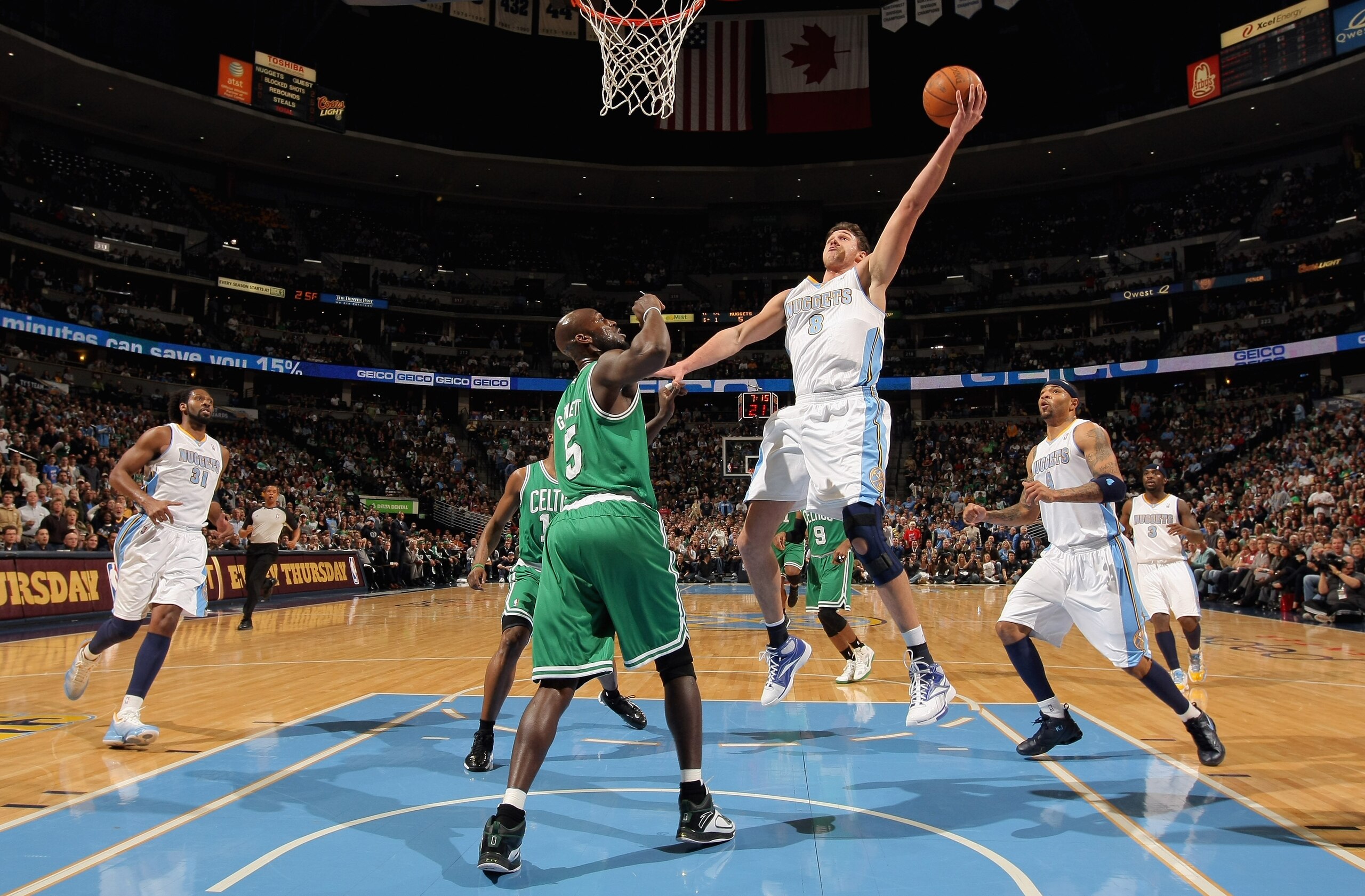 DENVER, CO - FEBRUARY 24:  Danilo Gallinari #8 of the Denver Nuggets lays up a shot against Kevin Garnett #5 of the Boston Celtics during NBA action at the Pepsi Center on February 24, 2011 in Denver, Colorado. NOTE TO USER: User expressly acknowledges an