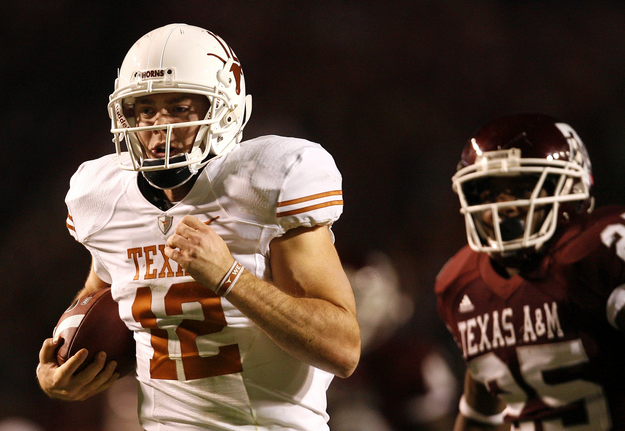 COLLEGE STATION, TX - NOVEMBER 26: Quarterback Colt McCoy #12 of the Texas Longhorns scrambles away from the Texas A&M Aggies defense to score a touchdown in the first half at Kyle Field on November 26, 2009 in College Station, Texas. he Longhorns defeate