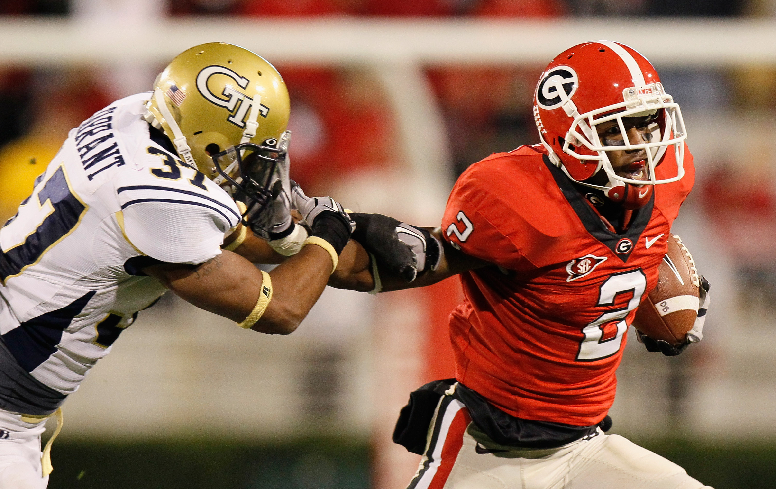 ATHENS, GA - NOVEMBER 27:  Brandon Boykin #2 of the Georgia Bulldogs stiff arms Jerrard Tarrant #37 of the Georgia Tech Yellow Jackets on a return at Sanford Stadium on November 27, 2010 in Athens, Georgia.  (Photo by Kevin C. Cox/Getty Images)