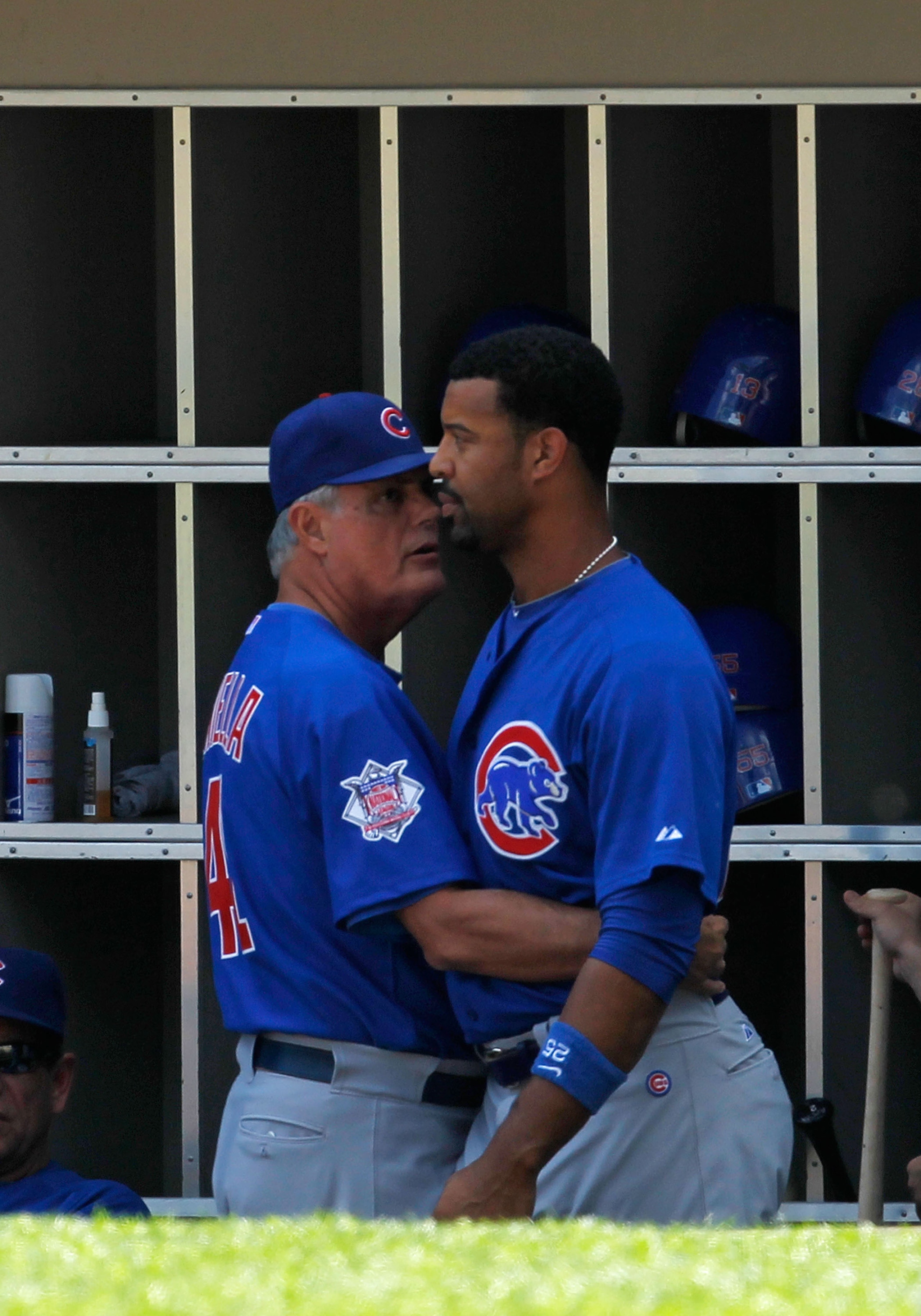 CHICAGO - JUNE 25: Manager Lou Piniella #41 of the Chicago Cubs talks with Derrek Lee #25 after Lee had a confrontation with starting pitcher Carlos Zambrano in the dugout during a game against the Chicago White Sox at U.S. Cellular Field on June 25, 2010