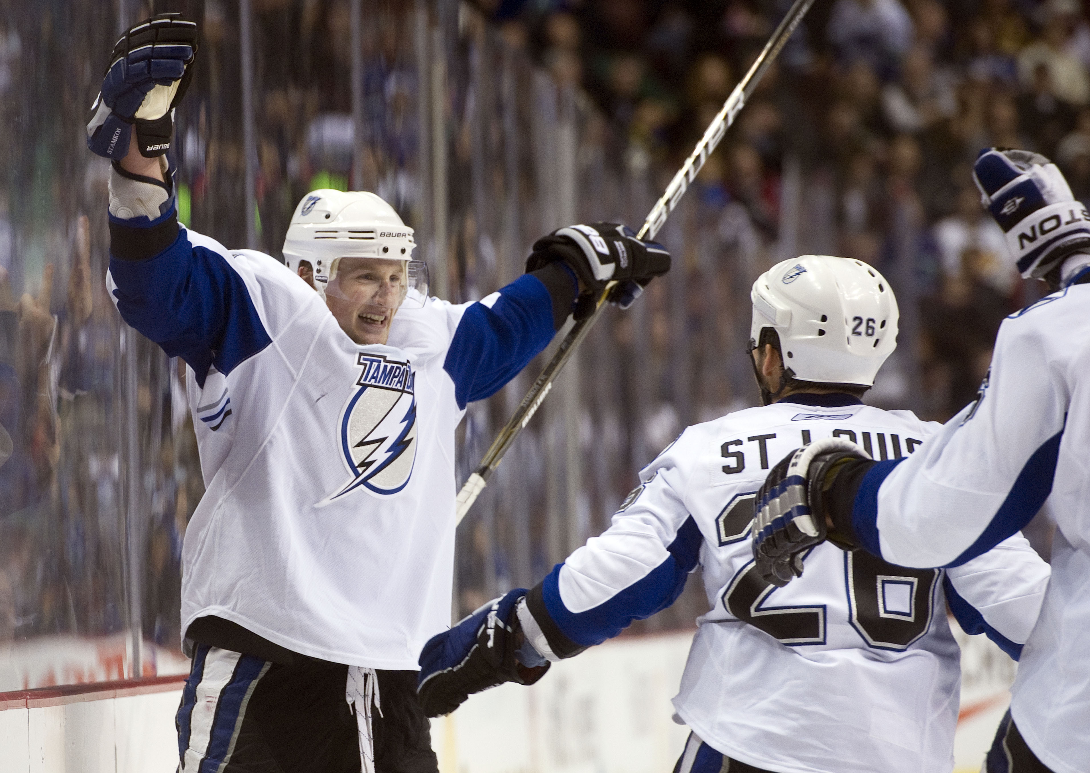 VANCOUVER, CANADA - DECEMBER 11: Steven Stamkos #91 of the Tampa Bay Lightning celebrates with Martin St Louis #26 after scoring against the Vancouver Canucks in overtime to win 5-4 during NHL action on December 11, 2010 at Rogers Arena in Vancouver, BC,