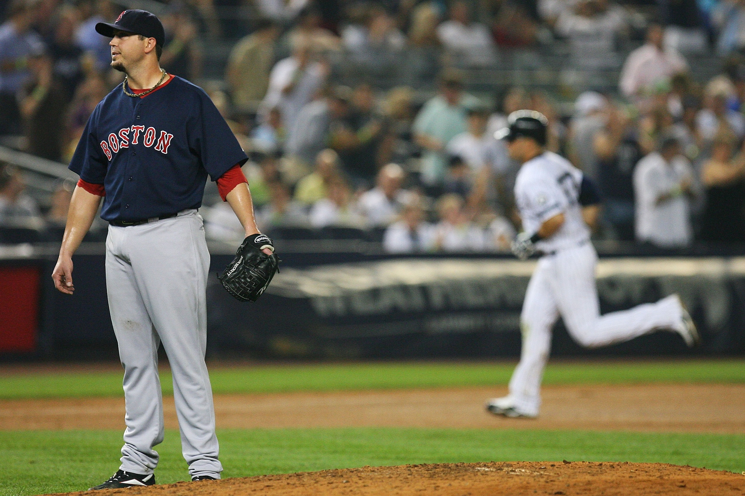 NEW YORK - SEPTEMBER 24:  Josh Beckett #19 of the Boston Red Sox looks on after allowing a two run home run from  Nick Swisher #33 (background) of the New York Yankees in the seventh inning on September 24, 2010 at Yankee Stadium in the Bronx borough of N