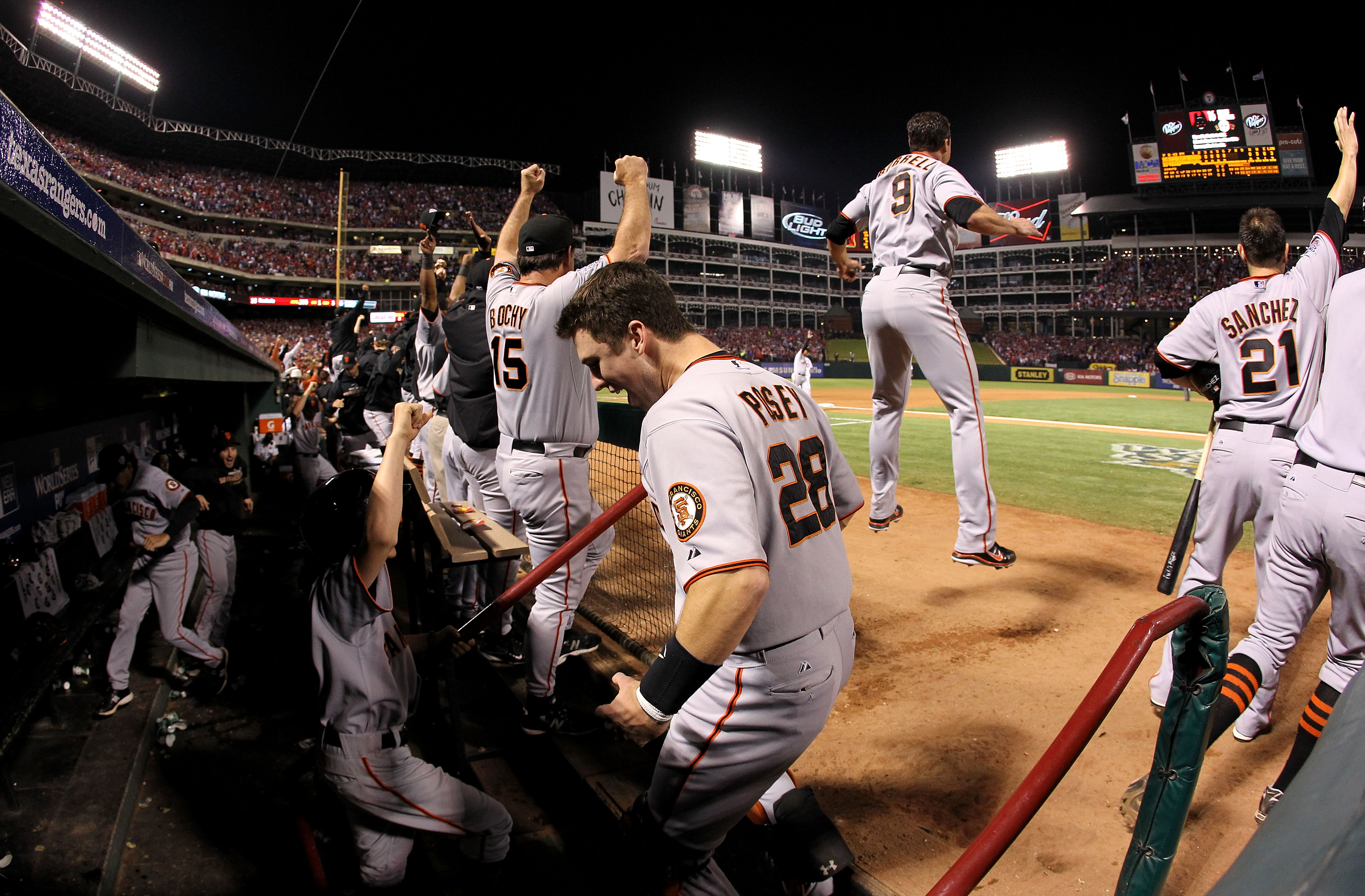 ARLINGTON, TX - NOVEMBER 01:  (L-R) Manager Bruce Bochy, Buster Posey #28, Pat Burrell #9 and Freddy Sanchez #21 of the San Francisco Giants celebrate as Edgar Renteria hit a 3-run home run in the seventh inning against the Texas Rangers in Game Five of t