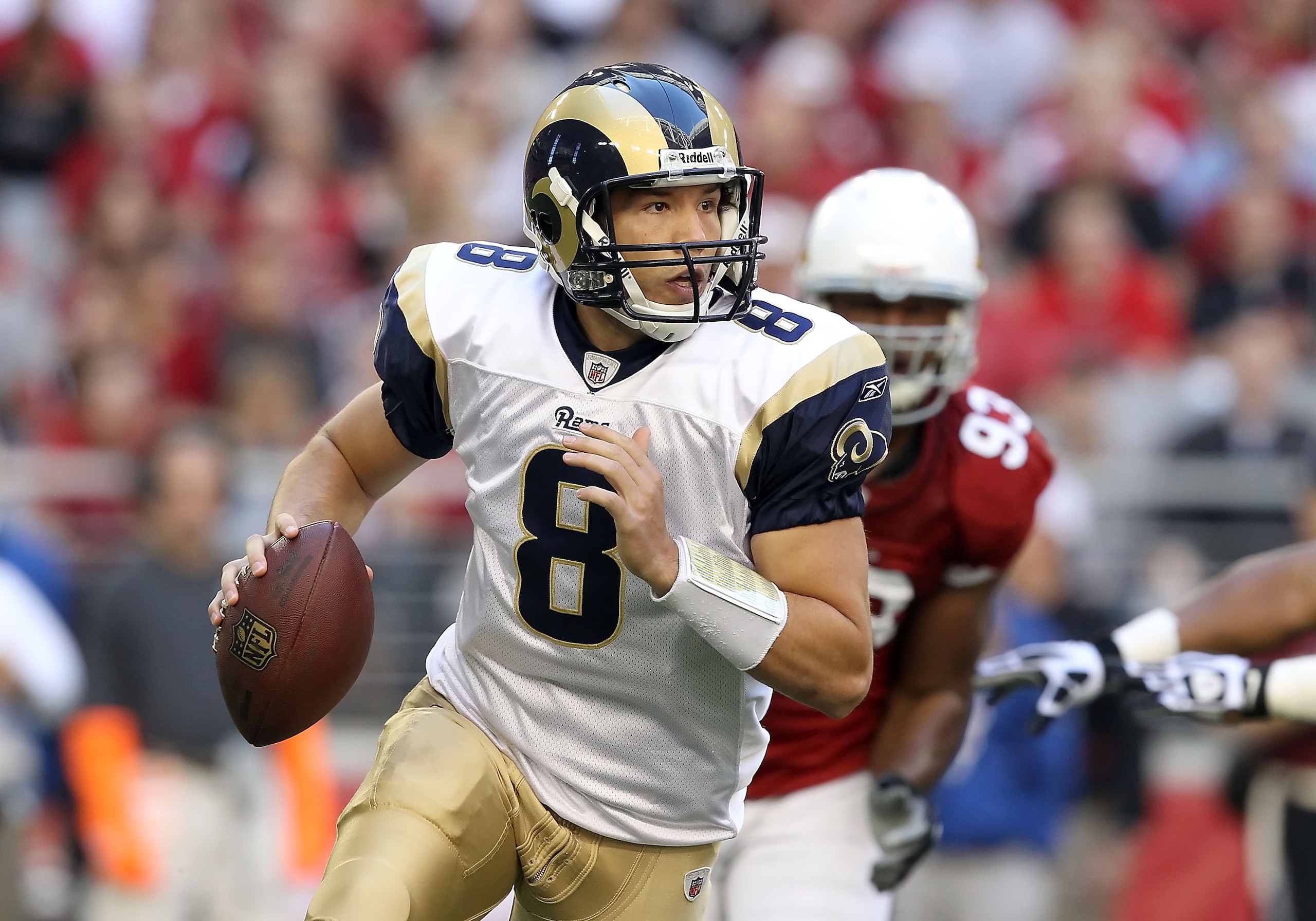 GLENDALE, AZ - DECEMBER 05:  Quarterback Sam Bradford #8 of the St. Louis Rams scrambles with the football during the NFL game against the Arizona Cardinals at the University of Phoenix Stadium on December 5, 2010 in Glendale, Arizona.  (Photo by Christia