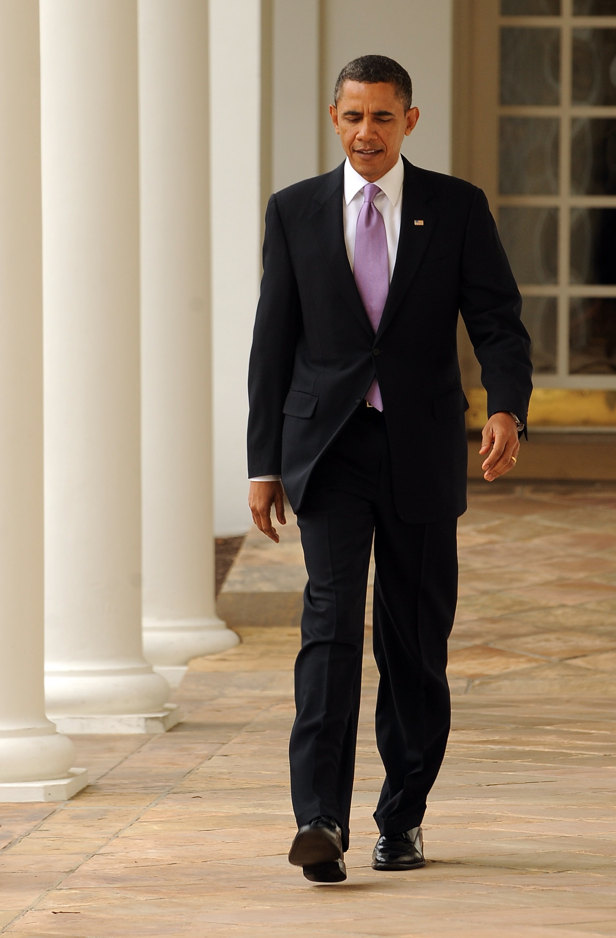 WASHINGTON, DC - JANUARY 25:  (AFP OUT) U.S. President Barack Obama walks through the Colonnade of the Rose Garden of the White House on January 25, 2011 in Washington, DC. Later this evening Obama will give his State of the Union Address to the Joint Ses