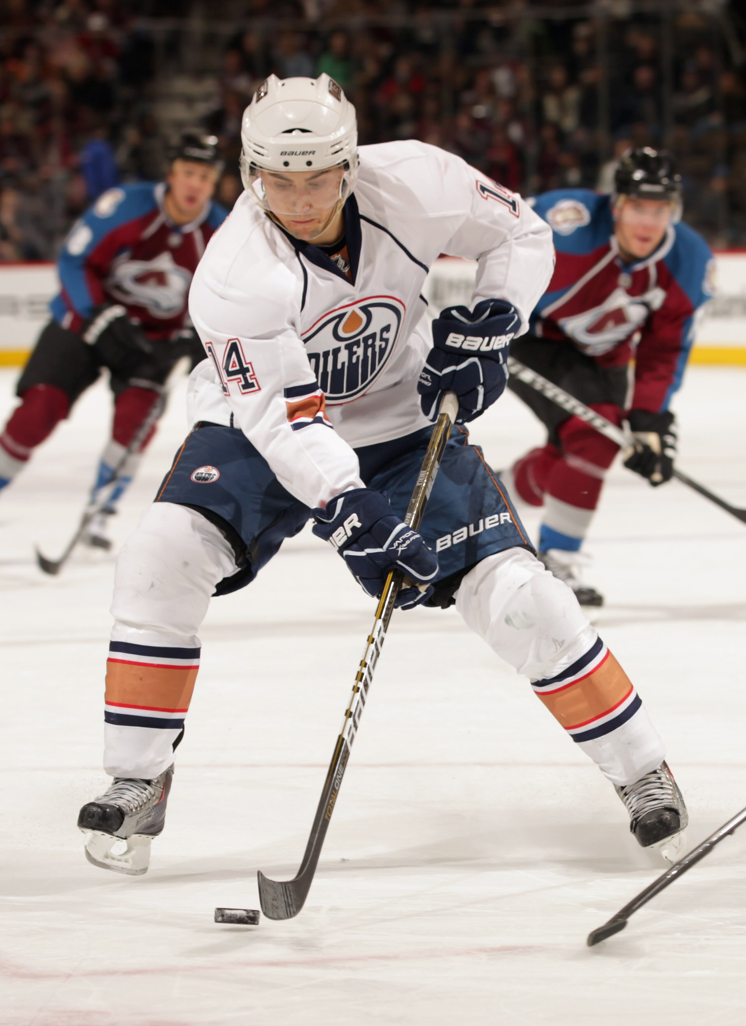 DENVER, CO - FEBRUARY 23:  Jordan Eberle #14 of the Edmonton Oilers controls the puck against the Colorado Avalanche at the Pepsi Center on February 23, 2011 in Denver, Colorado. The Oilers defeated the Avlanche 5-1.  (Photo by Doug Pensinger/Getty Images