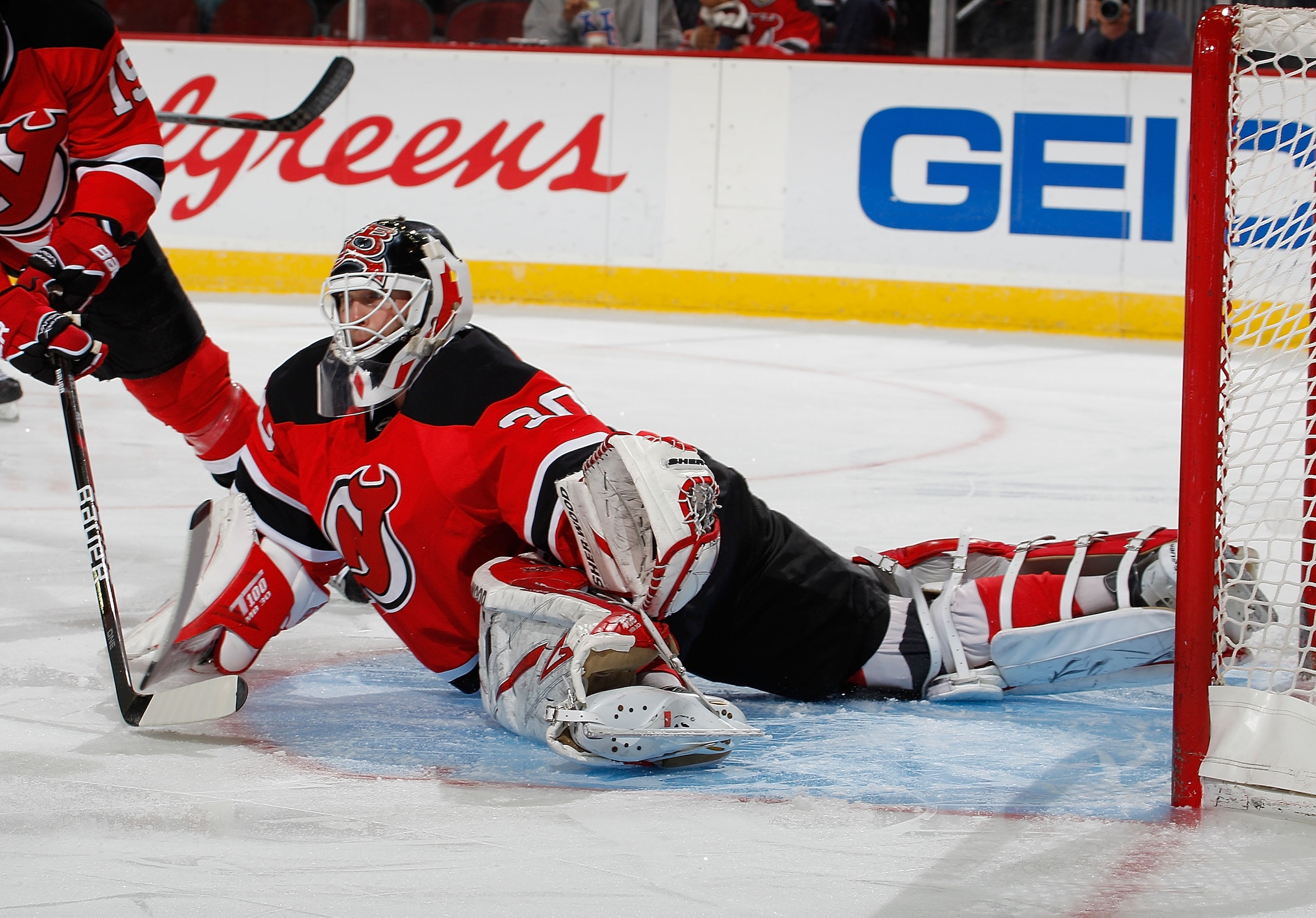 NEWARK, NJ - MARCH 02:  Martin Brodeur #30 of the New Jersey Devils makes a diving save during the first period of an NHL hockey game against the Tampa Bay Lightning at the Prudential Center on March 2, 2011 in Newark, New Jersey.  (Photo by Paul Bereswil