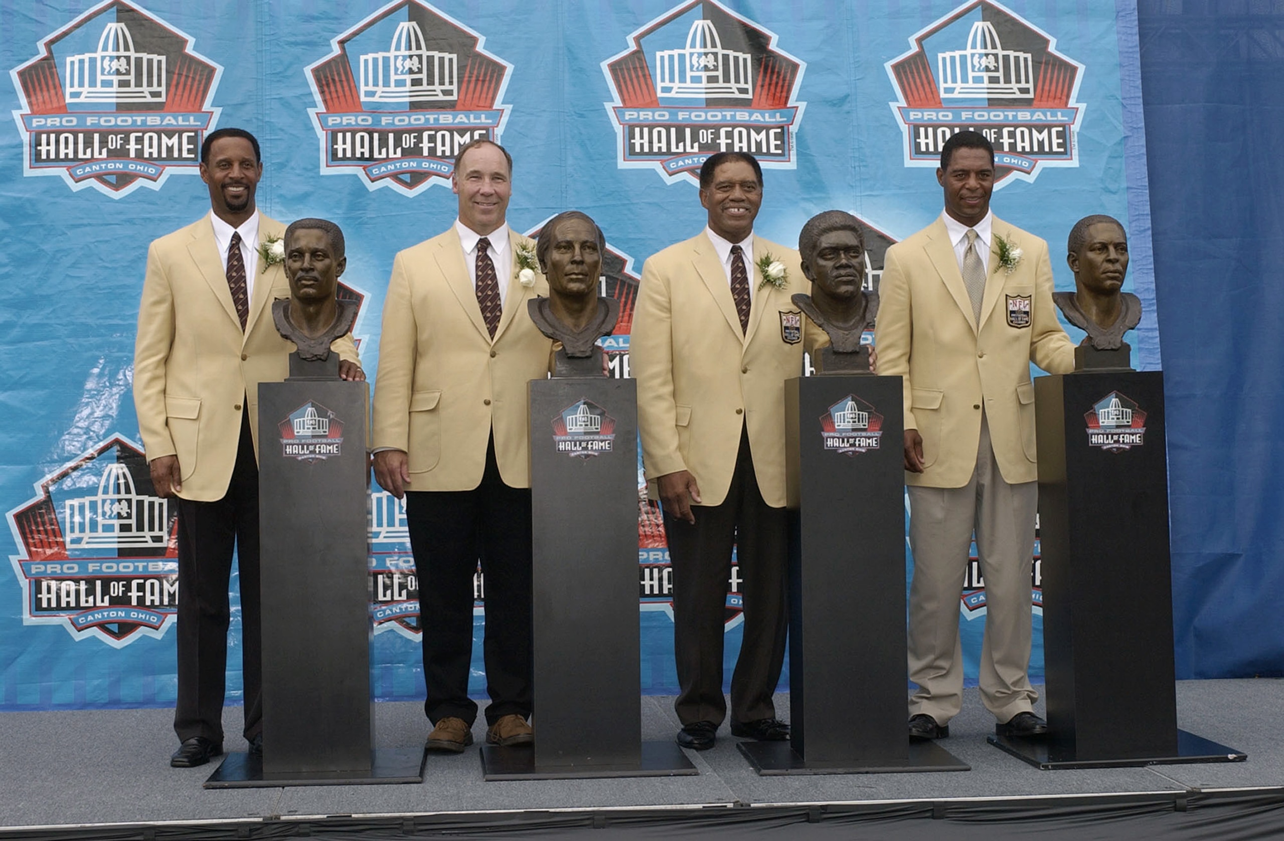 CANTON, OH - AUGUST 3:  (L-R) Pro Football Hall of Fame inductees (from left) James Lofton, Joe DeLamiellure, Elvin Betha, and Marcus Allen pose with their busts during the 2003 NFL Hall of Fame Induction ceremony on August 3, 2003 in Canton, Ohio.  (Phot