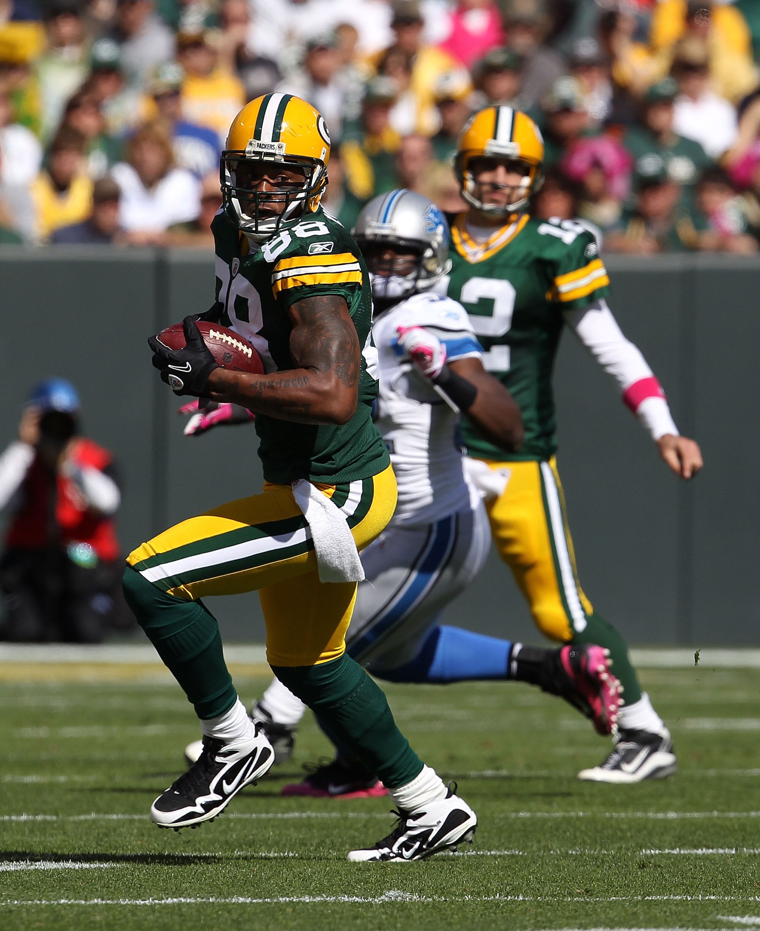 GREEN BAY, WI - OCTOBER 03: Jermichael Finley #88 of the Green Bay Packers runs with the ball after making a catch from Aaron Rodgers #12 against the Detroit Lions at Lambeau Field on October 3, 2010 in Green Bay, Wisconsin. The Packers defeated the Lions