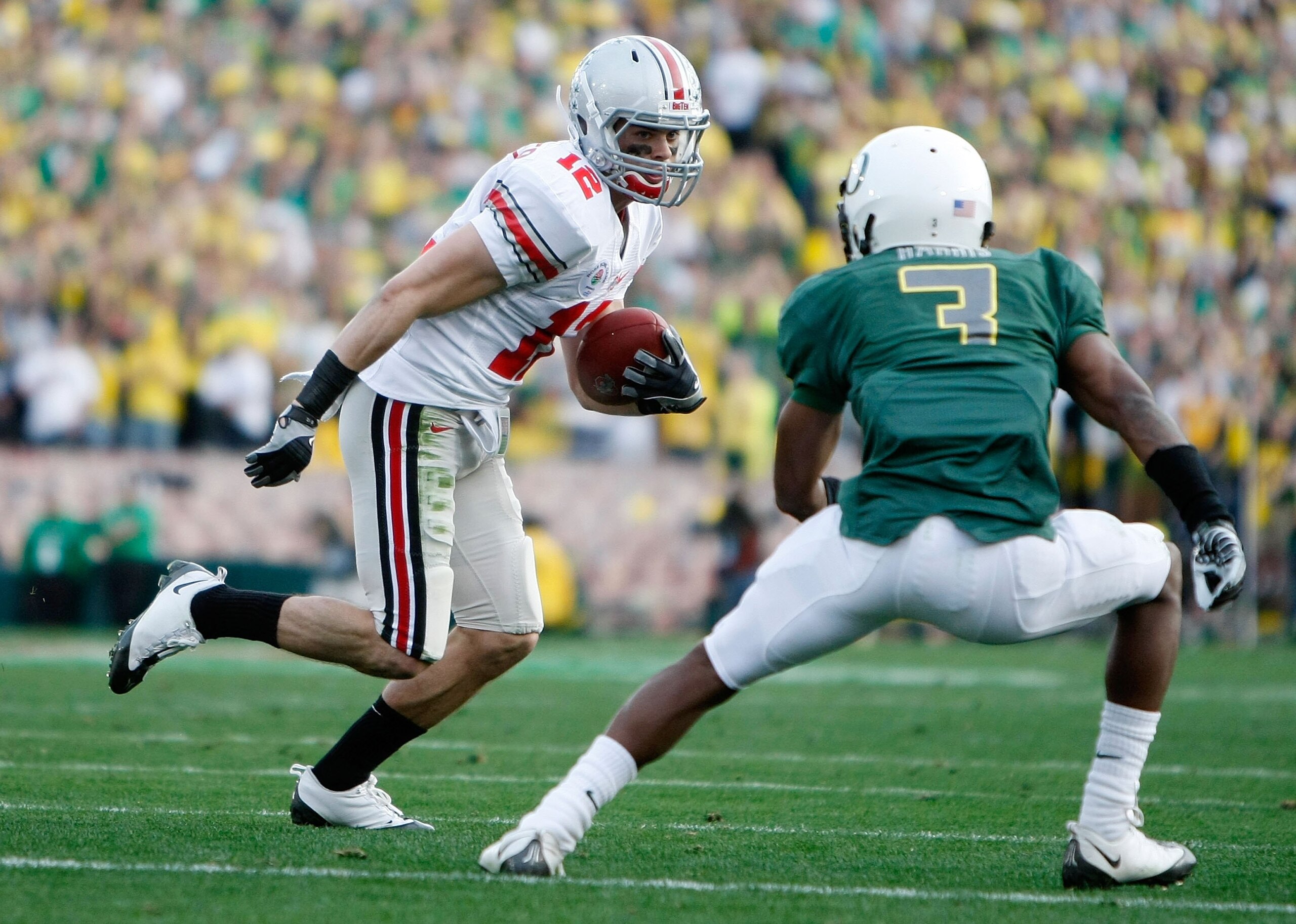 PASADENA, CA - JANUARY 01:  Wide receiver Dane Sanzenbacher #12 of the Ohio State Buckeyes runs with the ball against the Oregon Ducks during the 96th Rose Bowl game on January 1, 2010 in Pasadena, California.  (Photo by Jeff Gross/Getty Images)