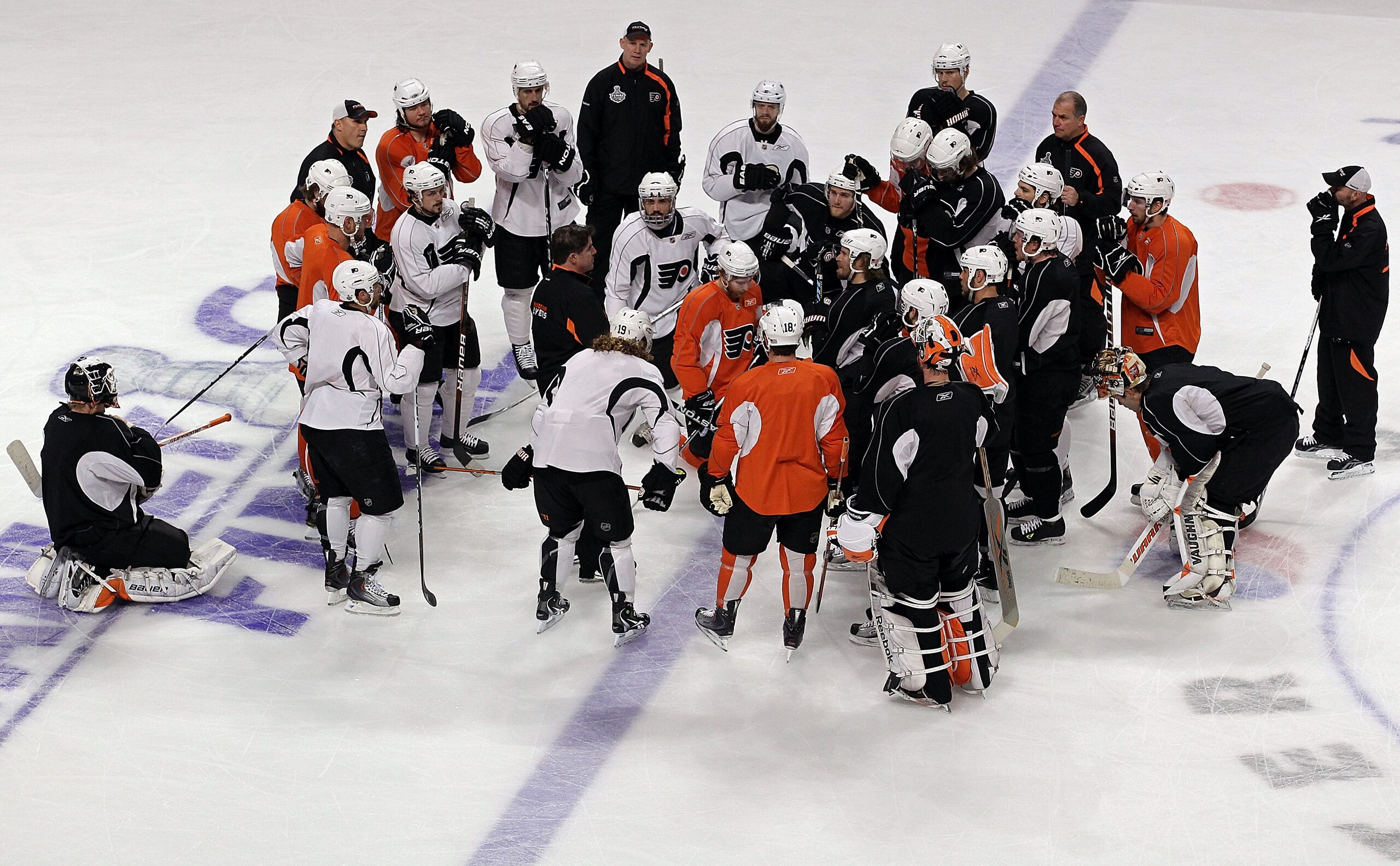 CHICAGO - MAY 30:  Head coach Peter Laviolette of the Philadelphia Flyers speaks to his team on the ice during a practice for the 2010 NHL Stanley Cup Finals at the United Center on May 30, 2010 in Chicago, Illinois.  (Photo by Bruce Bennett/Getty Images)