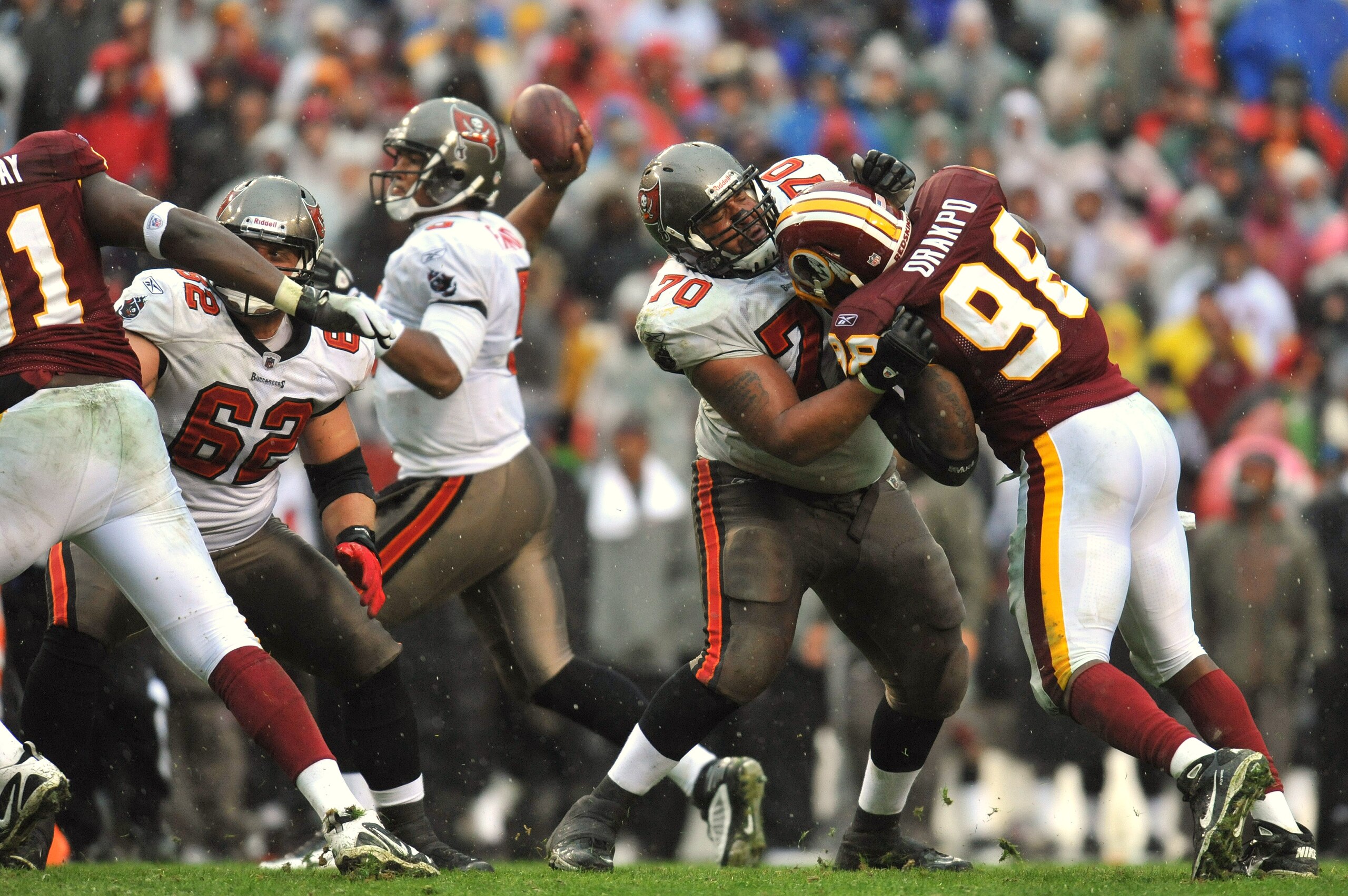 LANDOVER, MD - DECEMBER 12:  Donald Penn #70 of the Tampa Bay Buccaneers defends against Brian Orakpo #98 of the Washington Redskins at FedExField on December 12, 2010 in Landover, Maryland. The Buccaneers defeated the Redskins 17-16. (Photo by Larry Fren