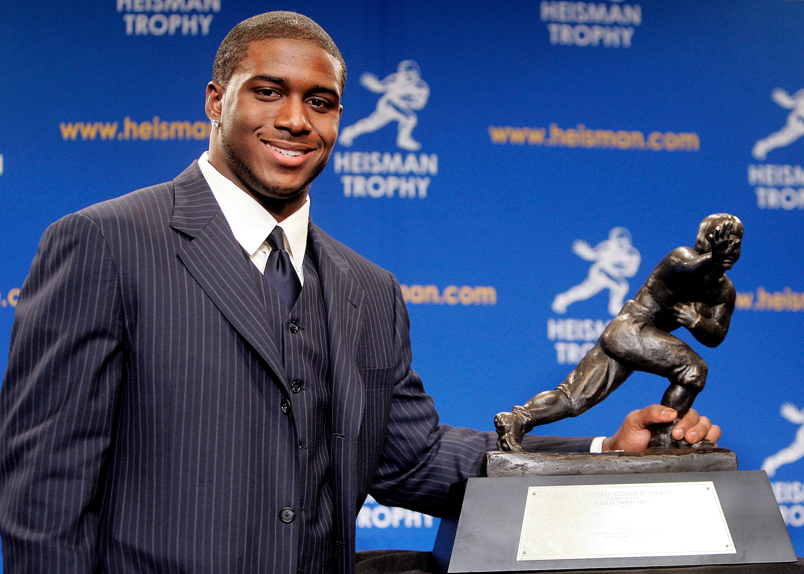 NEW YORK - DECEMBER 10:  Running back Reggie Bush #5 of the USC Trojans poses with the 2005 Heisman trophy after winning the award at the 71st Annual Heisman Ceremony on December 10, 2005 in New York City.  (Photo by Stephen Chernin/Getty Images)