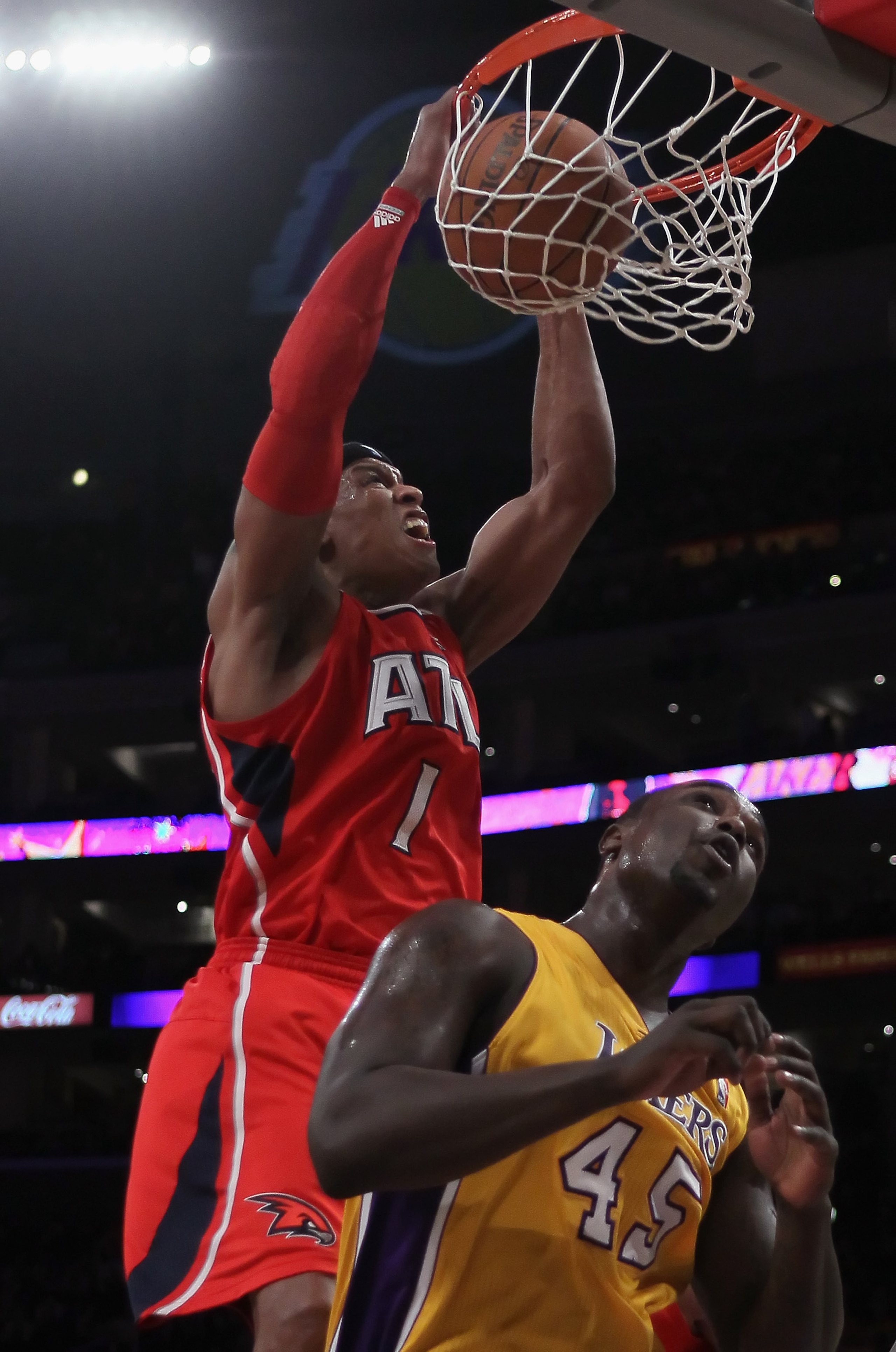 LOS ANGELES, CA - FEBRUARY 22:  Maurice Evans #1 of the Atlanta Hawks dunks over Derrick Caracter #45 of the Los Angeles Lakers in the second half at Staples Center on February 22, 2011 in Los Angeles, California. The Lakers defeated the Hawks 104-80. NOT