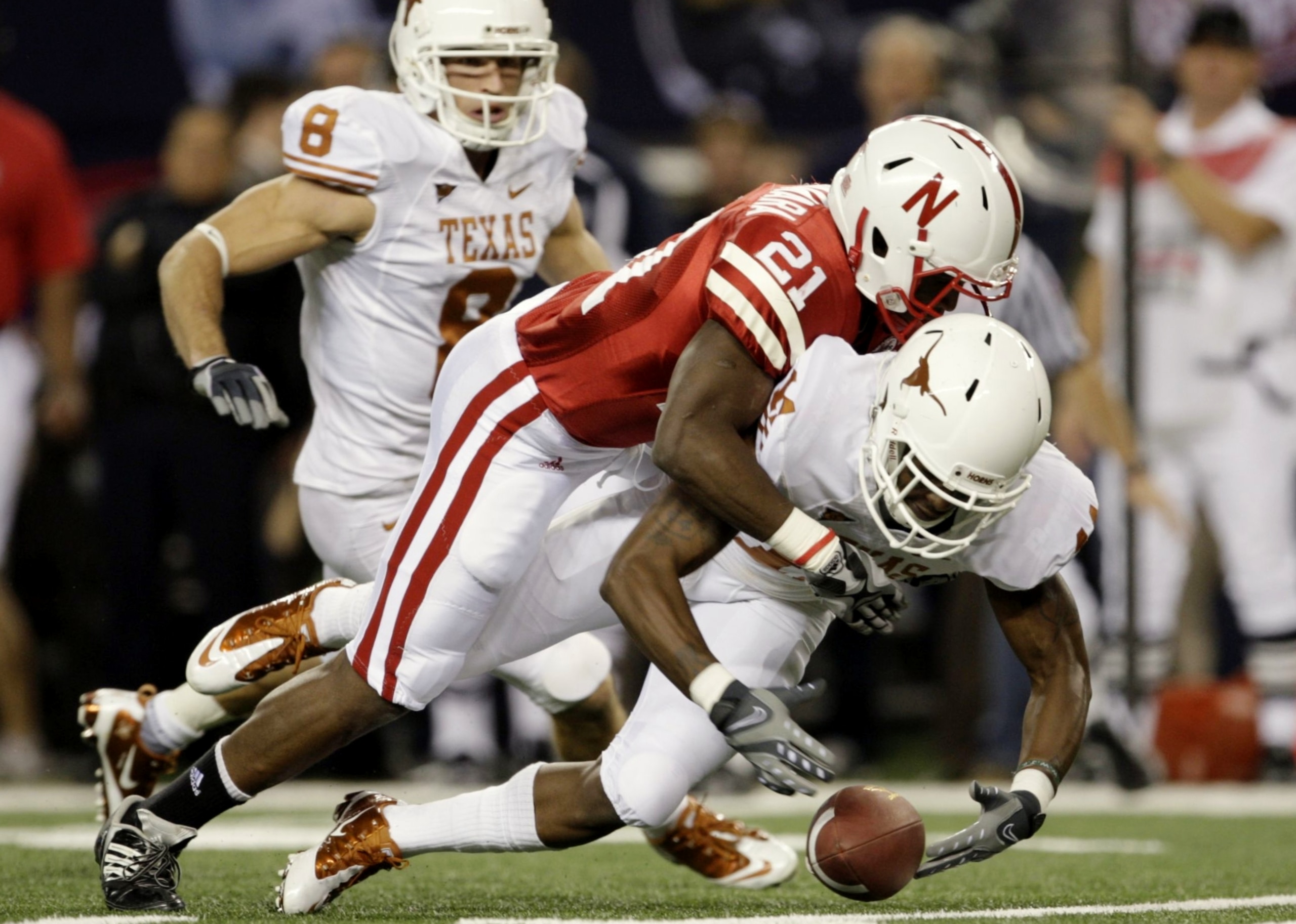 ARLINGTON, TX - DECEMBER 5:  Prince Amukamara #21 of the Nebraska Cornhuskers tackles James Kirkendoll #11 of the Texas Longhorns in the first quarter at Cowboys Stadium on December 5, 2009 in Arlington, Texas.  (Photo by Jamie Squire/Getty Images)