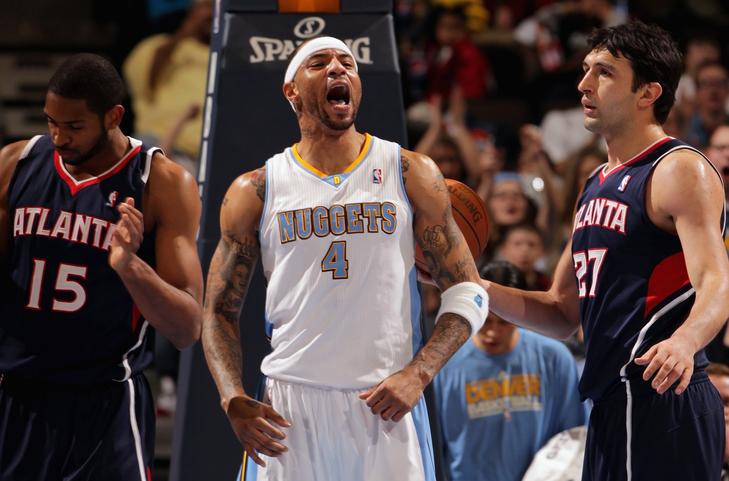 DENVER, CO - FEBRUARY 28:  Kenyon Martin #4 of the Denver Nuggets celebrates after scoring against Al Horford #15 and Zaza Pachulia #27 of the Atlanta Hawks during NBA action at the Pepsi Center on February 28, 2011 in Denver, Colorado. The Nuggets deafea