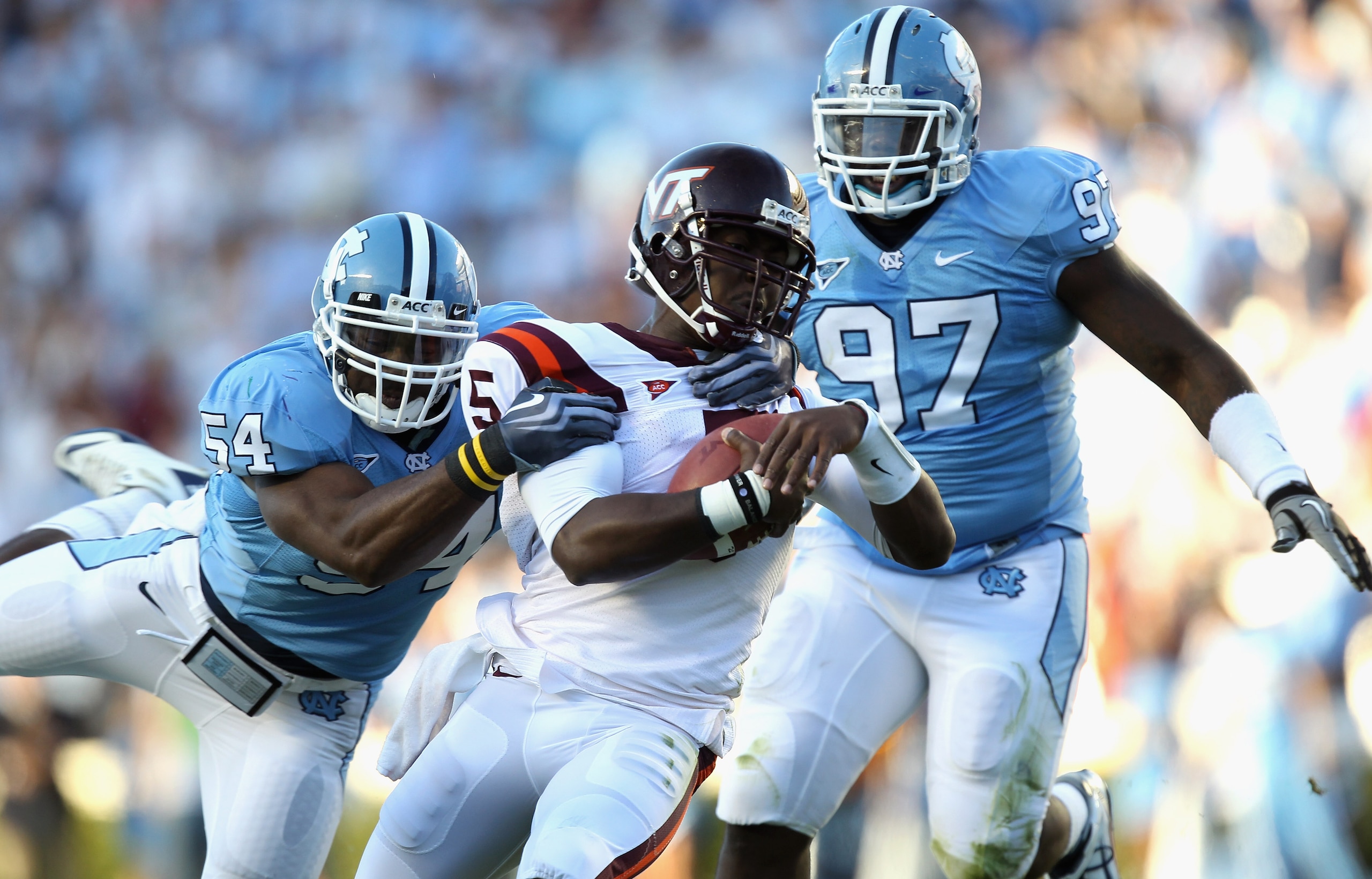 CHAPEL HILL, NC - NOVEMBER 13: Tyrod Taylor #5 of the Virginia Tech Hokies is tackled by Bruce Carter #54 and teammate Jared McAdoo #97 of the North Carolina Tar Heels during their game at Kenan Stadium on November 13, 2010 in Chapel Hill, North Carolina CHAPEL HILL, NC - NOVEMBER 13: Tyrod Taylor #5 of the Virginia Tech Hokies is tackled by Bruce Carter #54 and teammate Jared McAdoo #97 of the North Carolina Tar Heels during their game at Kenan Stadium on November 13, 2010 in Chapel Hill, North Carolina