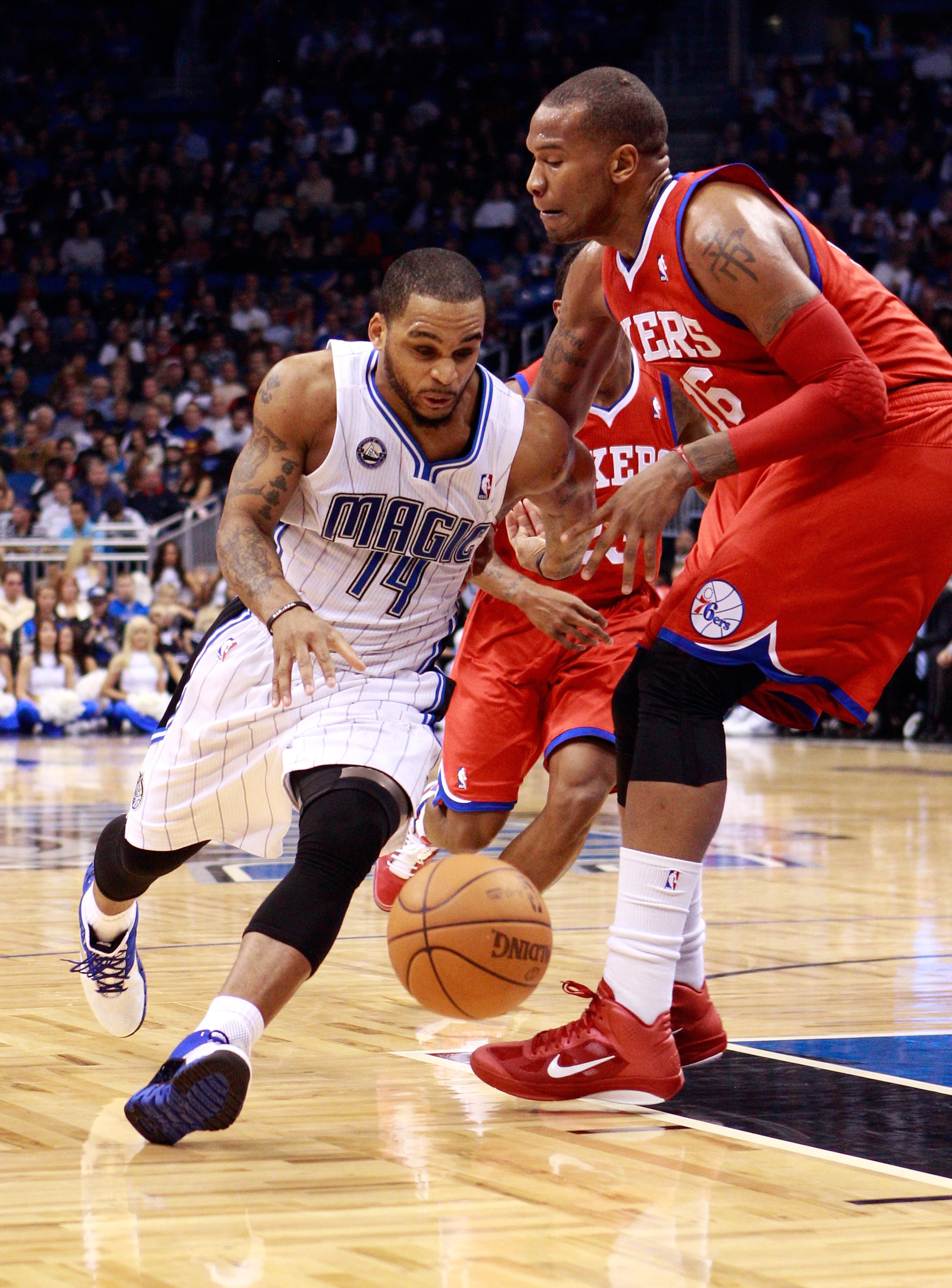 ORLANDO, FL - DECEMBER 18:  Jameer Nelson #14 of the Orlando Magic drives against Marreese Speights #16 of the Philadelphia 76ers during the game at Amway Arena on December 18, 2010 in Orlando, Florida.  NOTE TO USER: User expressly acknowledges and agree