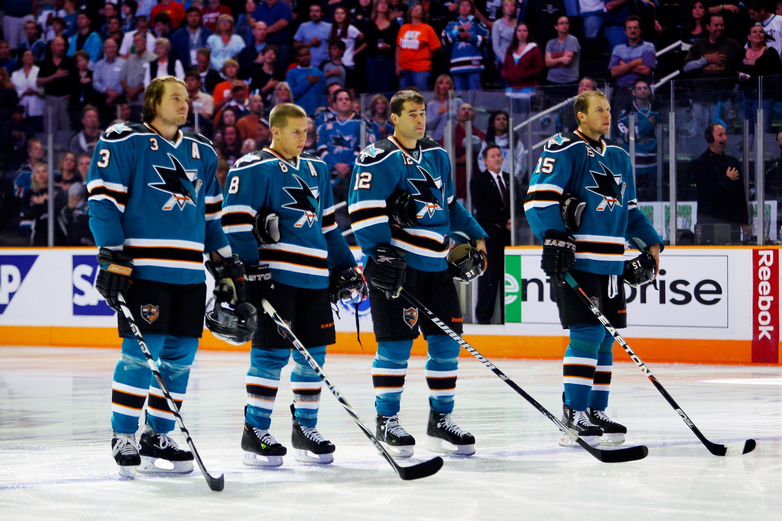 SAN JOSE, CA - SEPTEMBER 25: Douglas Murray #3, Joe Pavelski #8, Patrick Marleau #12, and Dany Heatley #15 of the San Jose Sharks stop for the national anthem before a preseason split-squad game against the Phoenix Coyotes at HP Pavilion on September 25,