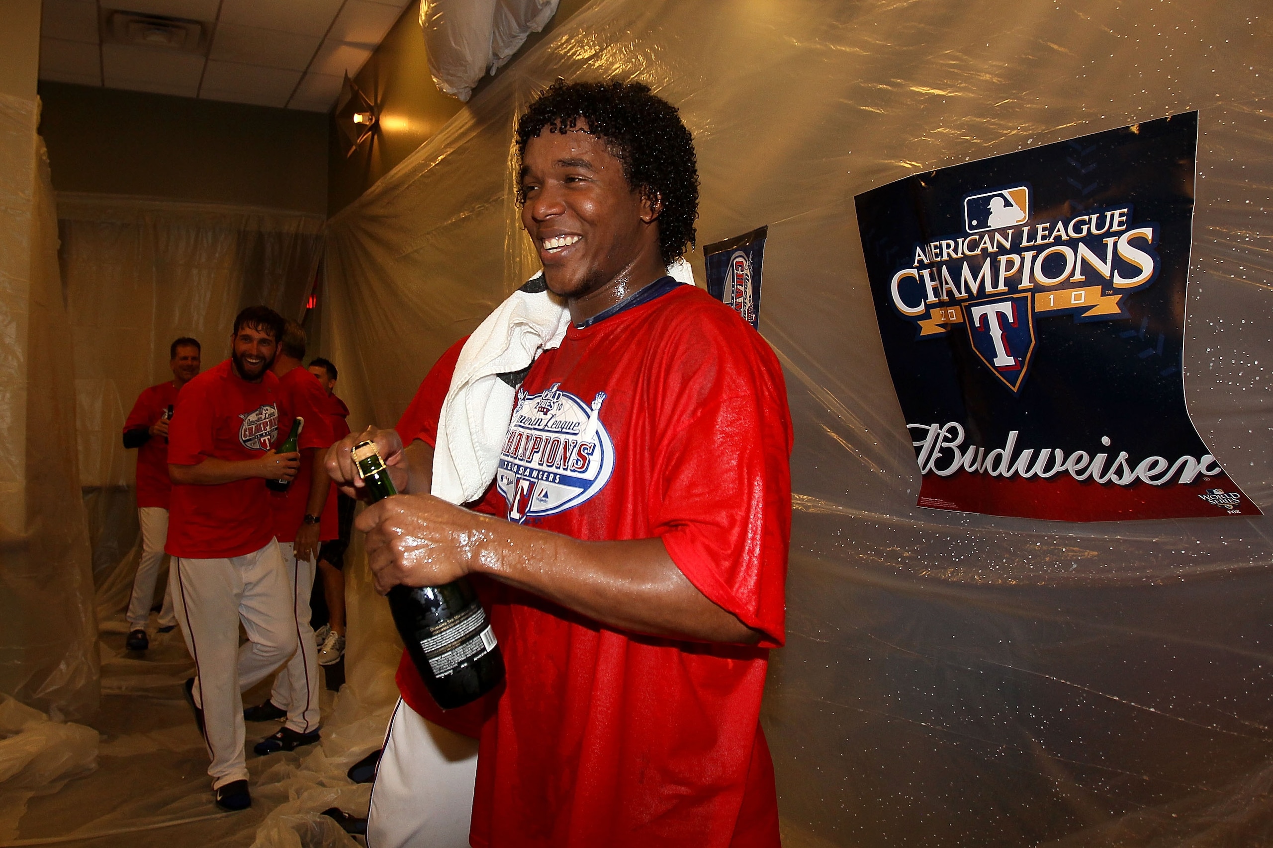 ARLINGTON, TX - OCTOBER 22:  Neftali Feliz #30 of the Texas Rangers sprays champagne in the lockerroom with after defeating the New York Yankees 6-1 in Game Six of the ALCS to advance to the World Series during the 2010 MLB Playoffs at Rangers Ballpark in