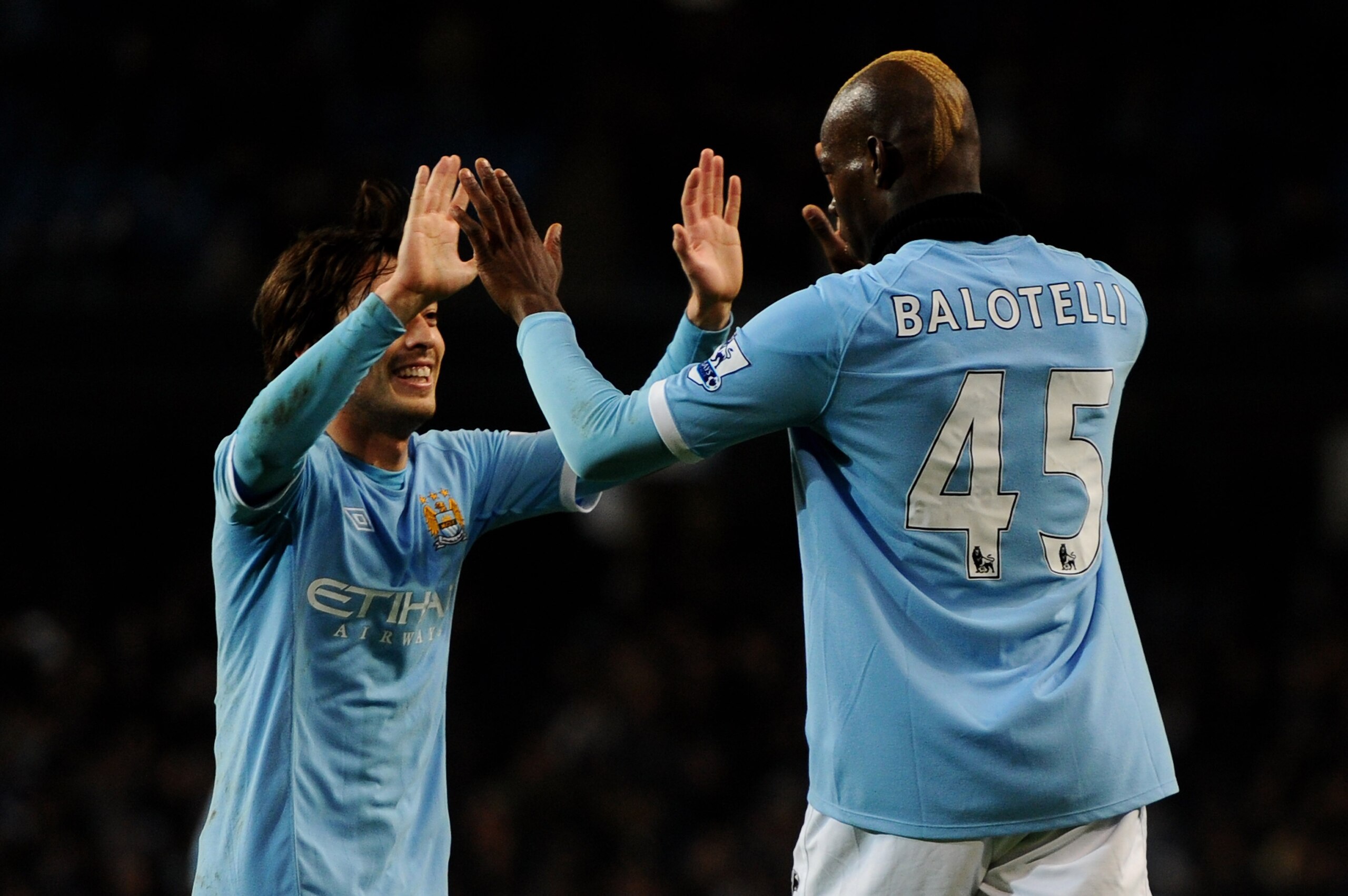 MANCHESTER, ENGLAND - MARCH 02:  Mario Balotelli of Manchester City celebrates scoring his team's second goal with team mate David Silva during the FA Cup sponsored by E.On Fifth Round match between Manchester City and Aston Villa at the City of Mancheste