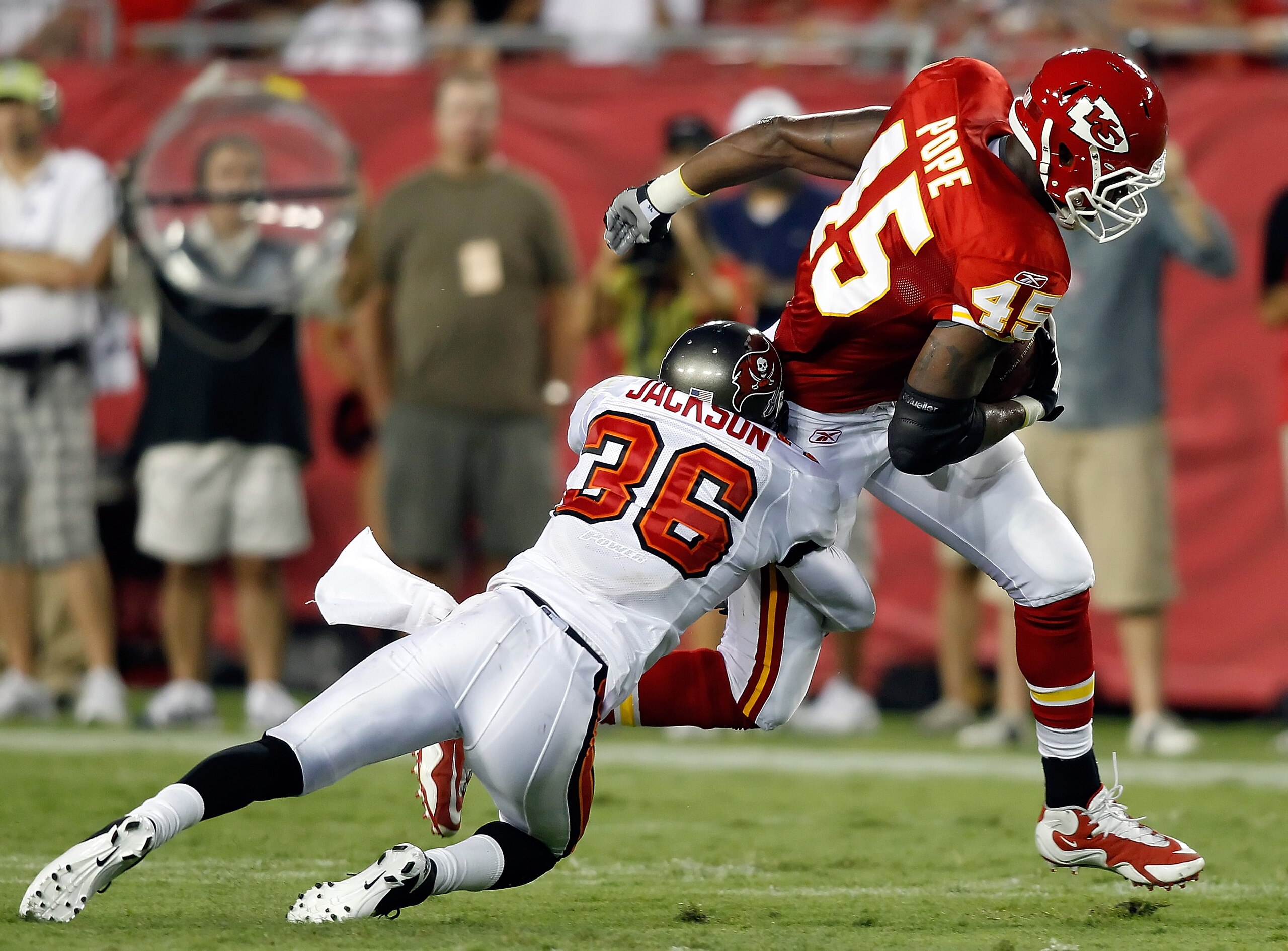 TAMPA, FL - AUGUST 21:  Safety Tanard Jackson #36 of the Tampa Bay Buccaneers tackles tight end Leonard Pope #45 of the Kansas City Chiefs during a preseason game at Raymond James Stadium on August 21, 2010 in Tampa, Florida.  (Photo by J. Meric/Getty Ima