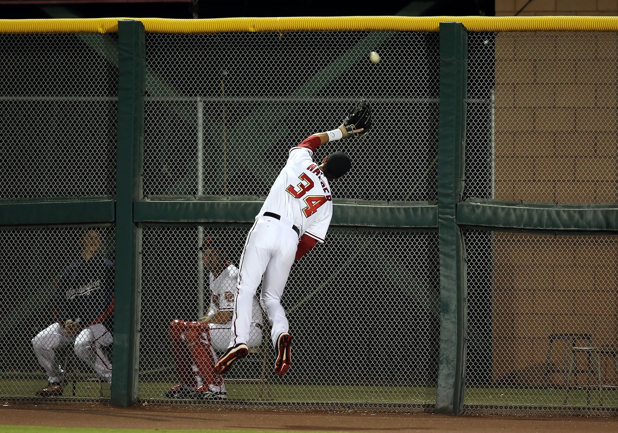 SCOTTSDALE, AZ - OCTOBER 20: Washington Nationals prospect, Bryce Harper #34 playing for the Scottsdale Scorpions leaps as he attempts to catch a double hit by the Mesa Solar Sox during the AZ Fall League game at Scottsdale Stadium on October 20, 2010 in SCOTTSDALE, AZ - OCTOBER 20: Washington Nationals prospect, Bryce Harper #34 playing for the Scottsdale Scorpions leaps as he attempts to catch a double hit by the Mesa Solar Sox during the AZ Fall League game at Scottsdale Stadium on October 20, 2010 in