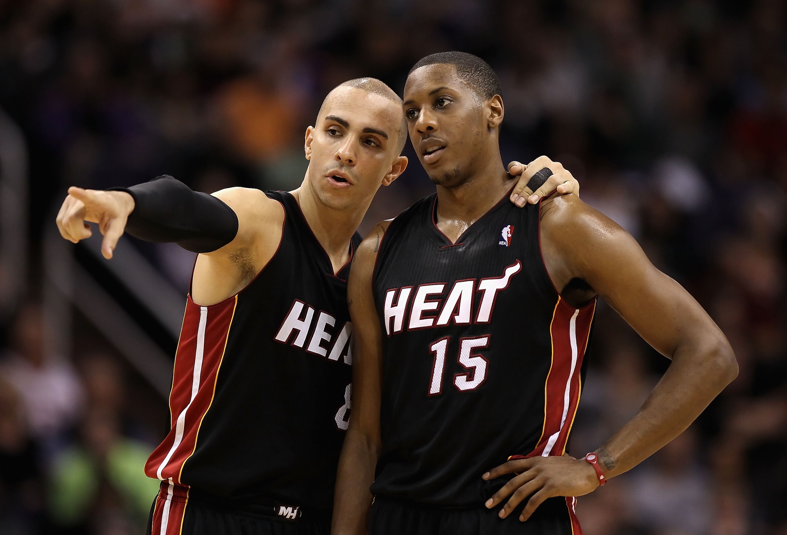 PHOENIX - DECEMBER 23: Carlos Arroyo #8 and Mario Chalmers #15 of the Miami Heat talk during the NBA game against the Phoenix Suns at US Airways Center on December 23, 2010 in Phoenix, Arizona. The Heat defeated the Suns 95-83. NOTE TO USER: User expres PHOENIX - DECEMBER 23: Carlos Arroyo #8 and Mario Chalmers #15 of the Miami Heat talk during the NBA game against the Phoenix Suns at US Airways Center on December 23, 2010 in Phoenix, Arizona. The Heat defeated the Suns 95-83. NOTE TO USER: User expres