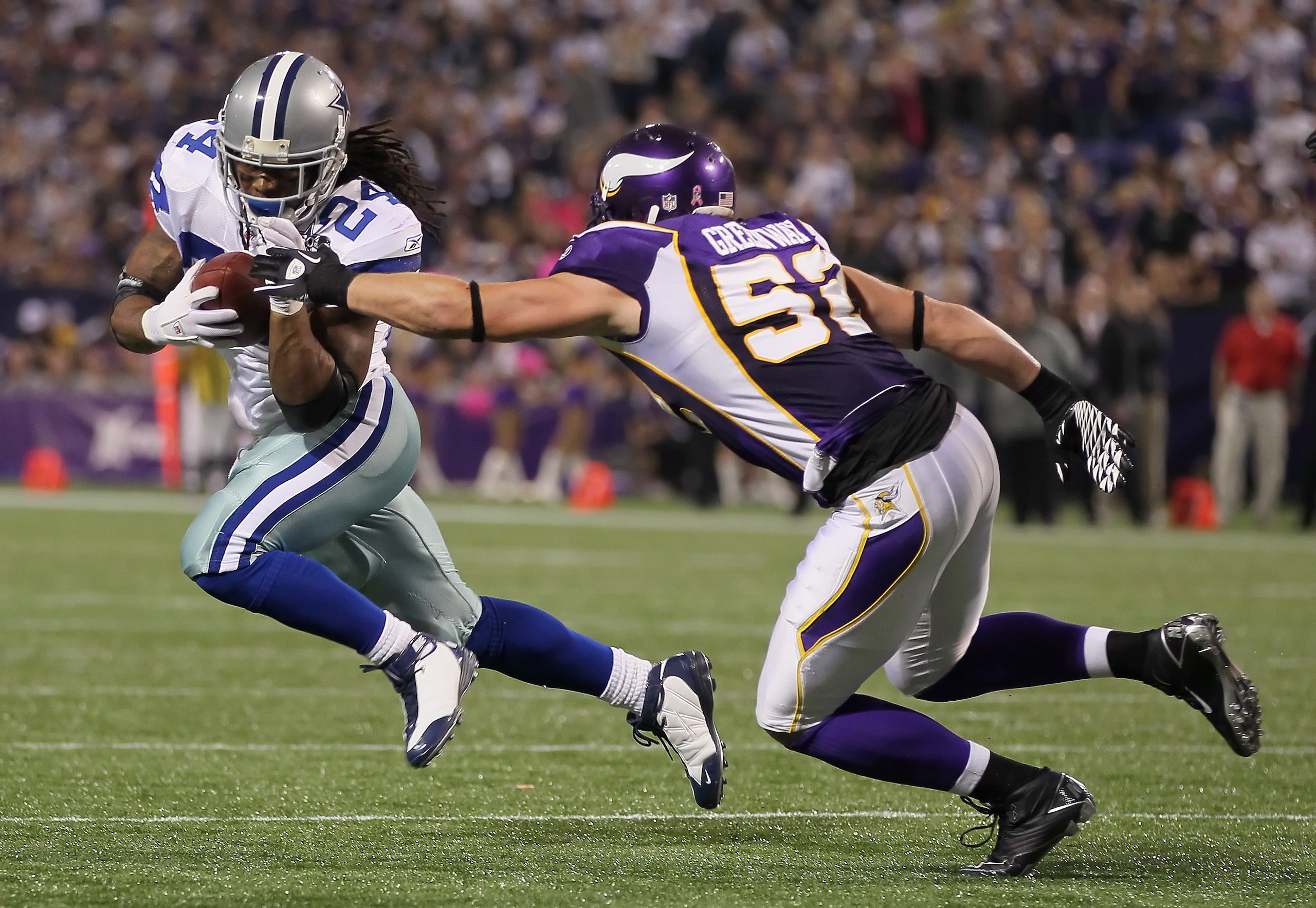 MINNEAPOLIS - OCTOBER 17:  Running back Marion Barber #24 of the Dallas Cowboys is pursued by Chad Greenway #52 of the Minnesota Vikings during the second quarter at Mall of America Field on October 17, 2010 in Minneapolis, Minnesota. The Vikings defeated