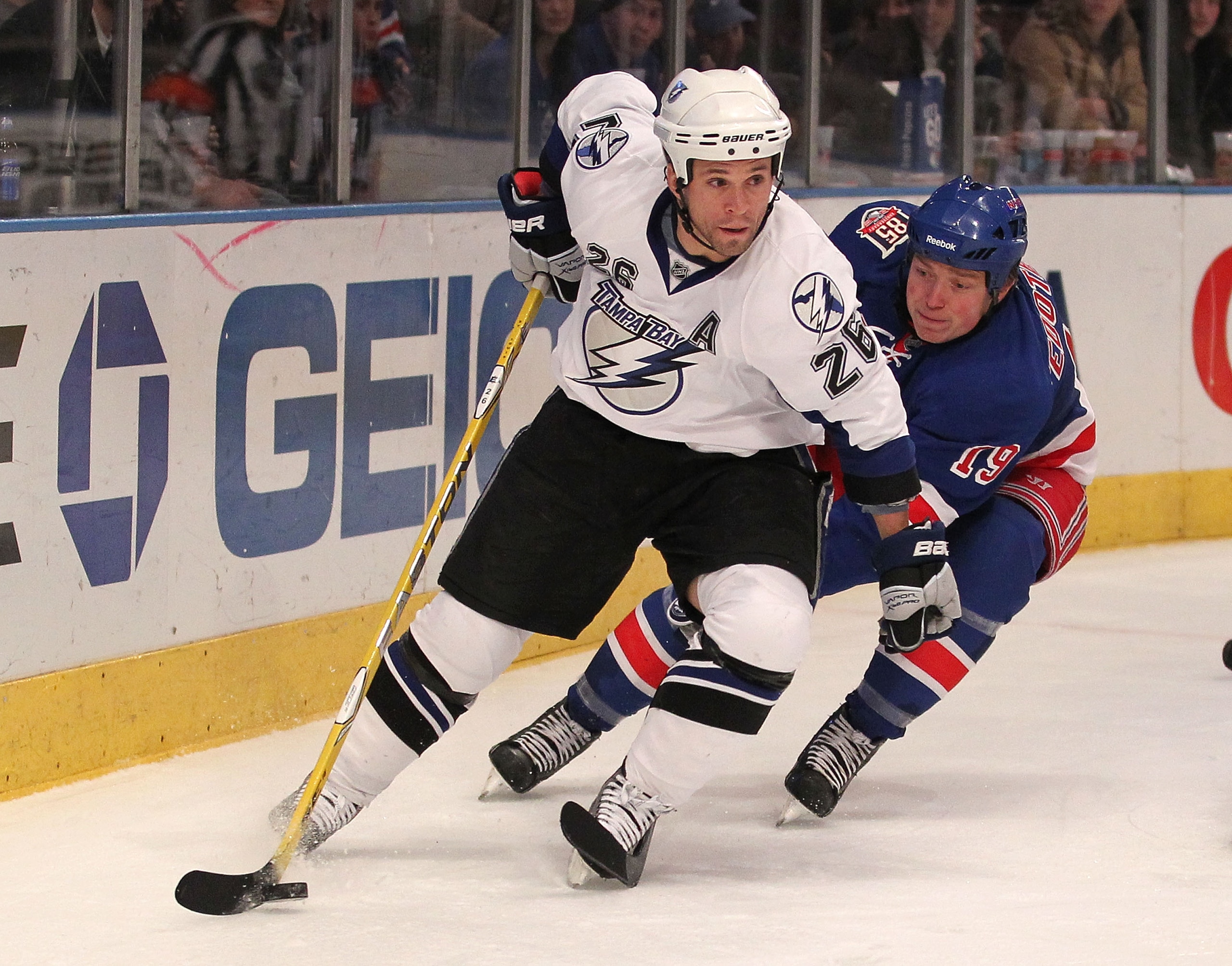 NEW YORK, NY - DECEMBER 23: Ruslan Fedotenko #19 of the New York Rangers tries to stop Martin St. Louis #26 of the Tampa Bay Lightning during the third period of an NHL hockey game at Madison Square Garden on December 23, 2010 in New York City. (Photo b NEW YORK, NY - DECEMBER 23: Ruslan Fedotenko #19 of the New York Rangers tries to stop Martin St. Louis #26 of the Tampa Bay Lightning during the third period of an NHL hockey game at Madison Square Garden on December 23, 2010 in New York City. (Photo b