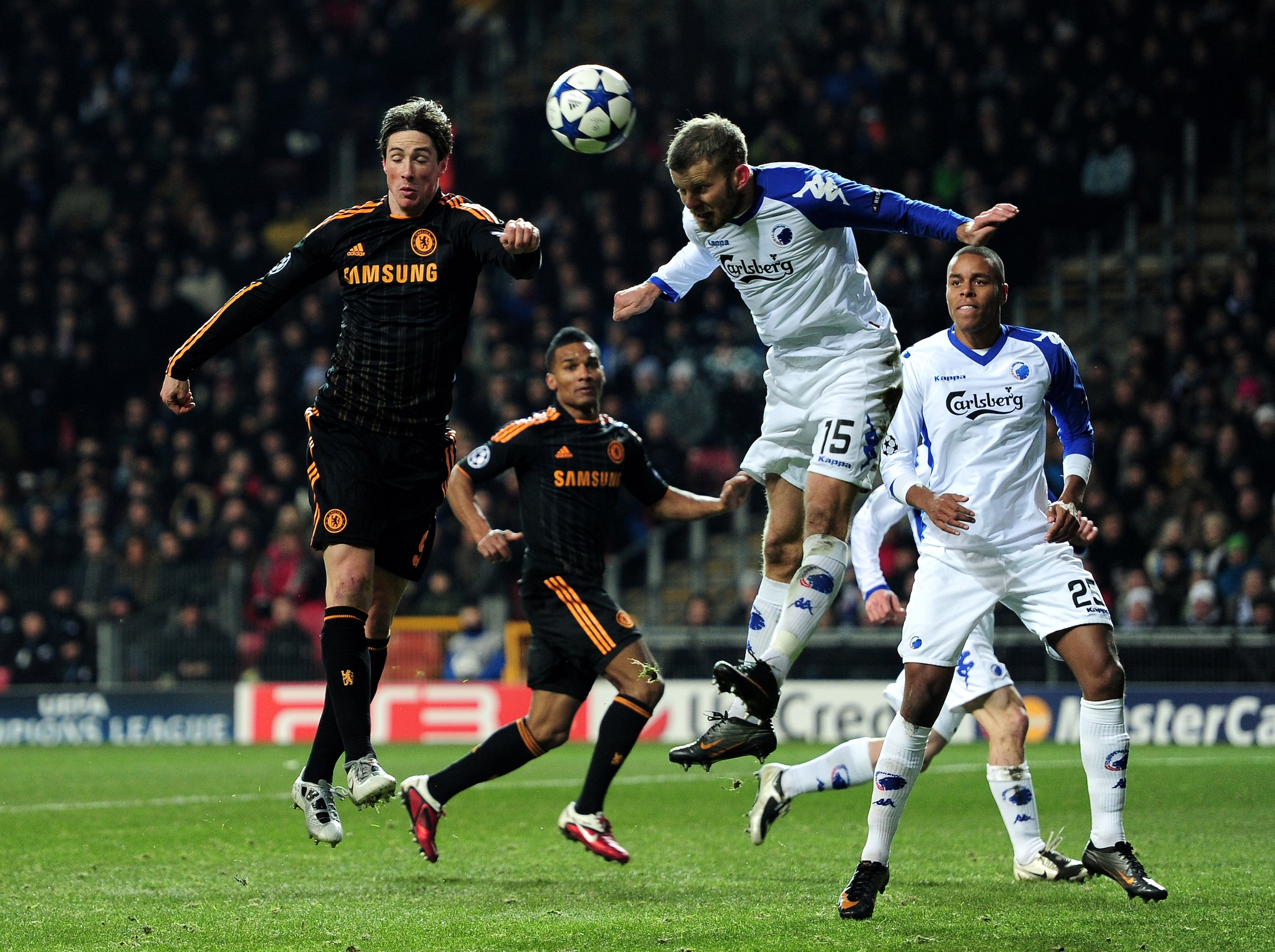 COPENHAGEN, DENMARK - FEBRUARY 22:  Fernando Torres of Chelsea competes in the air with Mikael Antonsson of FC Copenhagen during  the UEFA Champions League round of 16 first leg match between FC Copenhagen and Chelsea at Parken Stadium on February 22, 201