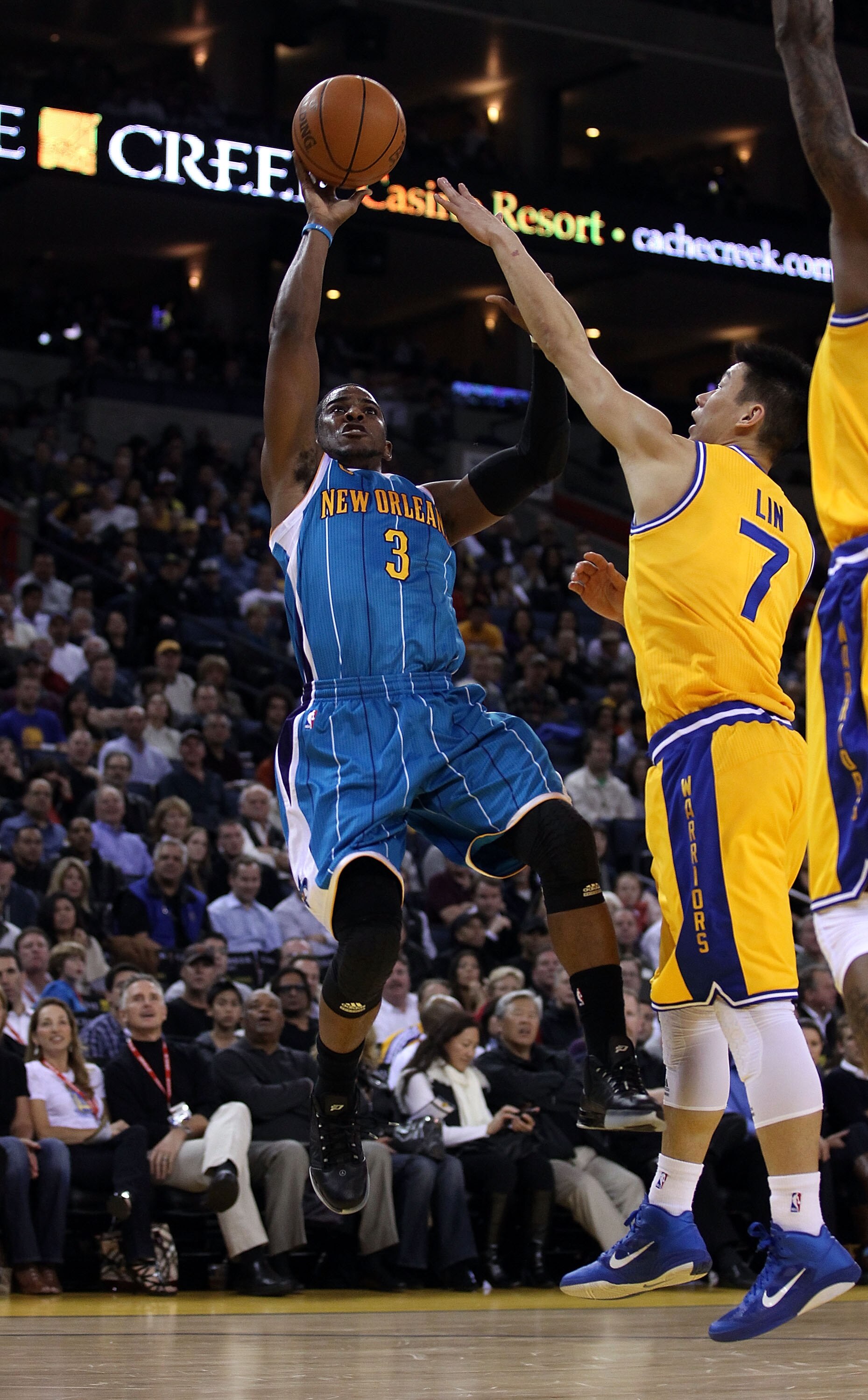 OAKLAND, CA - FEBRUARY 15: Chris Paul #3 of the New Orleans Hornets shoots over Jeremy Lin #7 of the Golden State Warriors at Oracle Arena on February 15, 2011 in Oakland, California. NOTE TO USER: User expressly acknowledges and agrees that, by download OAKLAND, CA - FEBRUARY 15: Chris Paul #3 of the New Orleans Hornets shoots over Jeremy Lin #7 of the Golden State Warriors at Oracle Arena on February 15, 2011 in Oakland, California. NOTE TO USER: User expressly acknowledges and agrees that, by download
