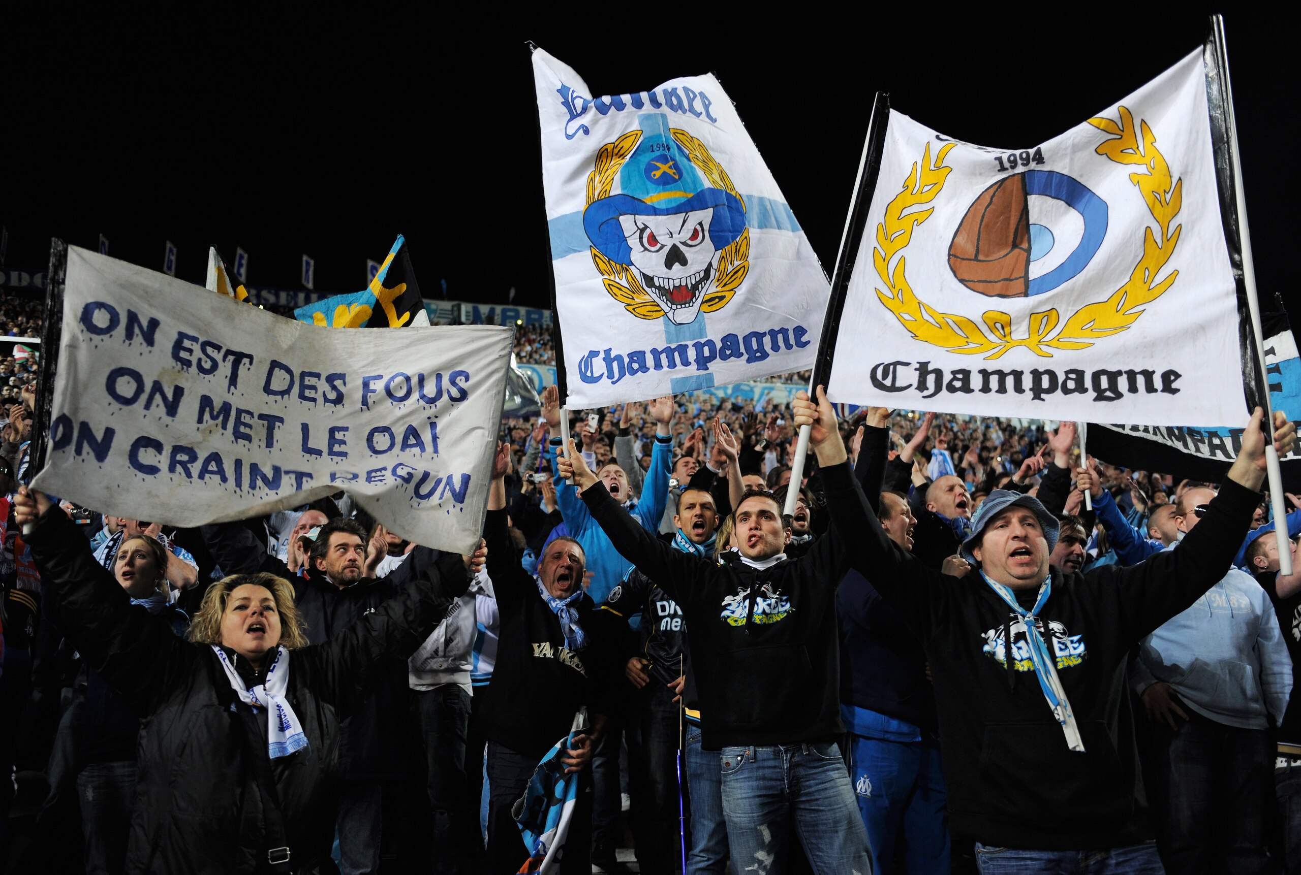 MARSEILLE, FRANCE - FEBRUARY 23: Marseille fans hold banners during the UEFA Champions League round of 16 first leg match between Marseille and Manchester United at the Stade Velodrome on February 23, 2011 in Marseille, France.  (Photo by Michael Regan/Ge