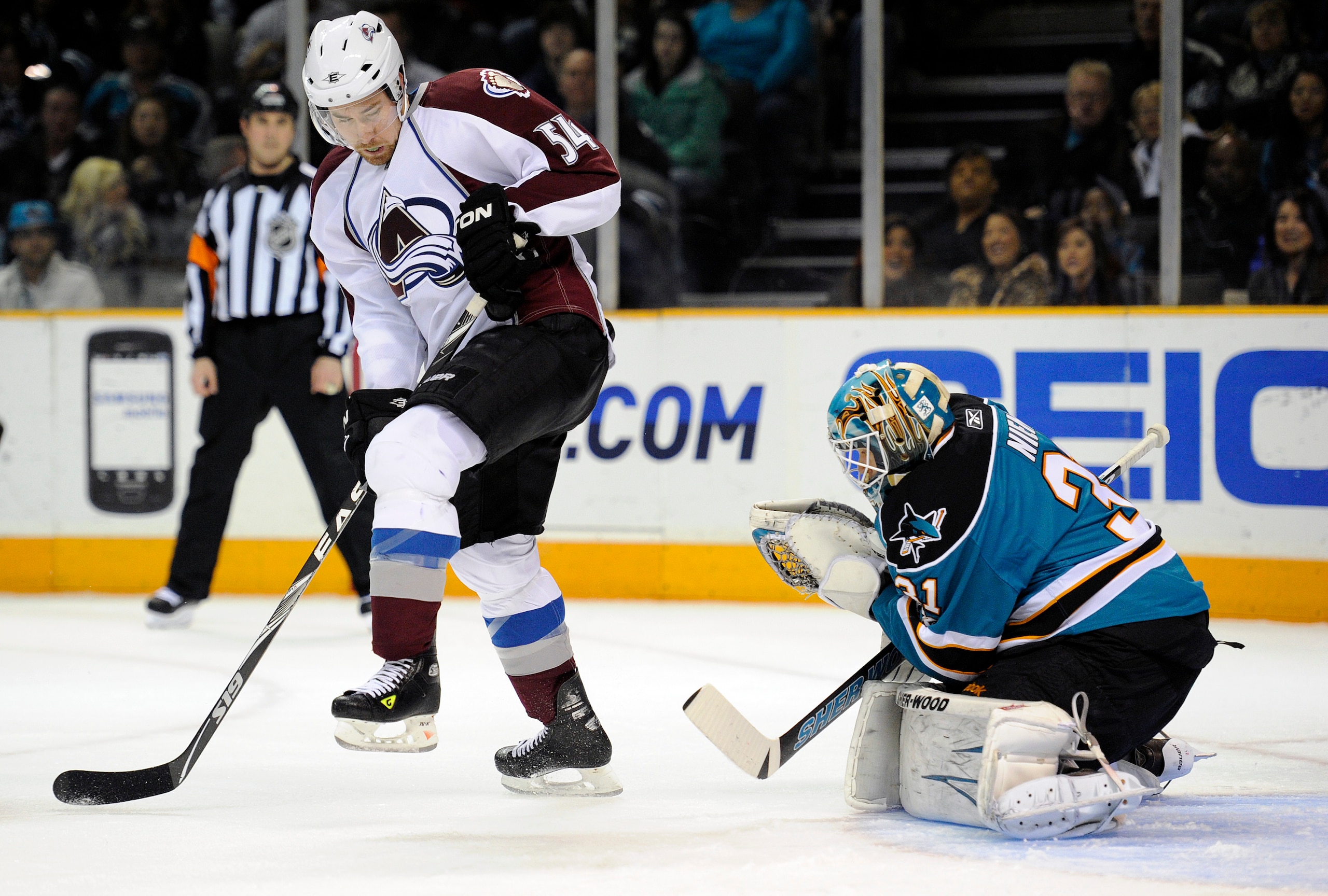 SAN JOSE, CA - MARCH 1: Antti Niemi #31 of the San Jose Sharks makes save as David Jones #54 of the Colorado Avalanche jumps out of the way of the shot in the first period during an NHL hockey game at the HP Pavilion on March 1, 2011 in San Jose, Californ