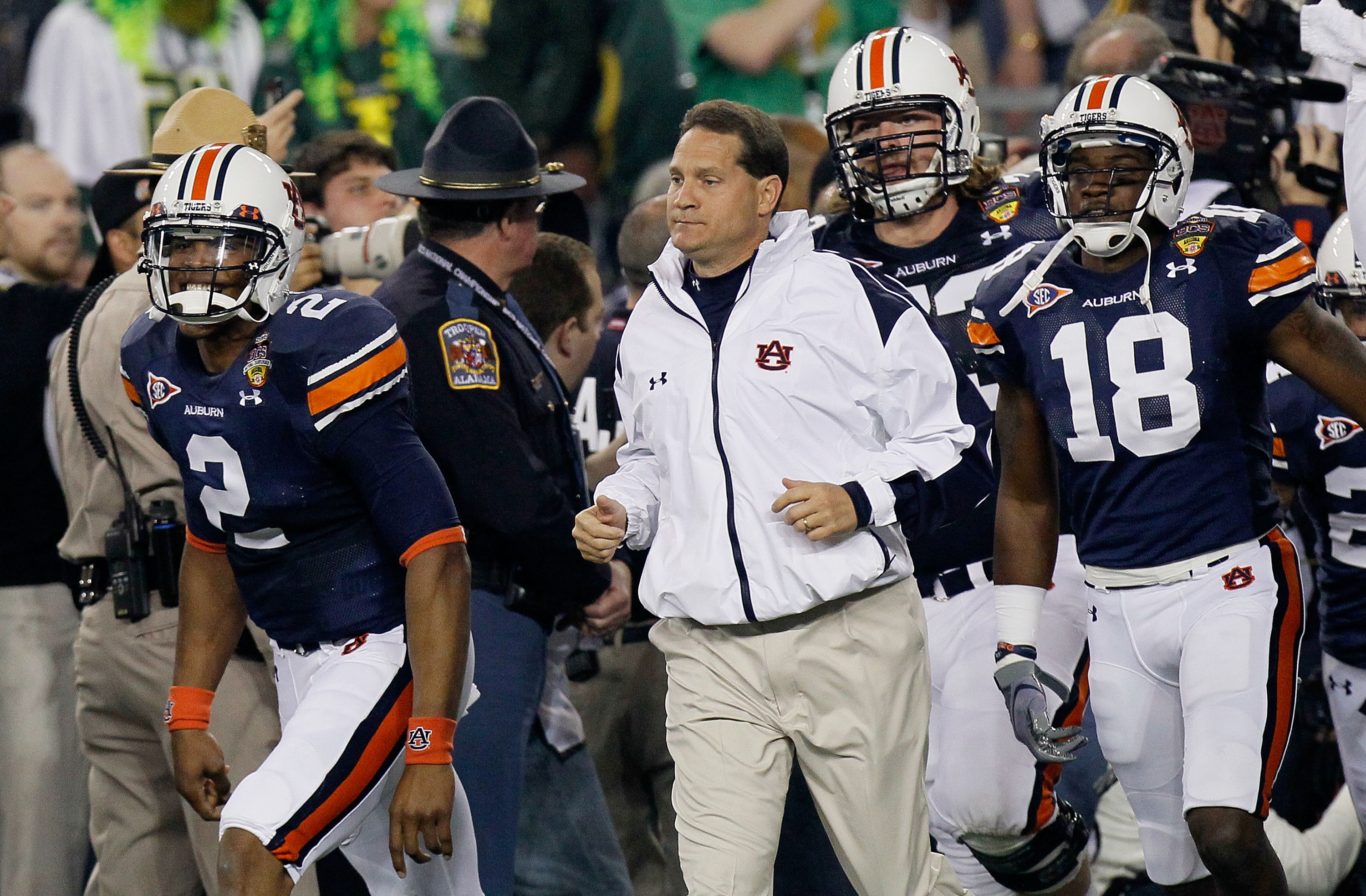 GLENDALE, AZ - JANUARY 10: Cameron Newton #2, Head coach Gene Chizik, Lee Ziemba #73 and Kodi Burns #18 of the Auburn Tigers react on the sideline against the Oregon Ducks during the Tostitos BCS National Championship Game at University of Phoenix Stadiu GLENDALE, AZ - JANUARY 10: Cameron Newton #2, Head coach Gene Chizik, Lee Ziemba #73 and Kodi Burns #18 of the Auburn Tigers react on the sideline against the Oregon Ducks during the Tostitos BCS National Championship Game at University of Phoenix Stadiu
