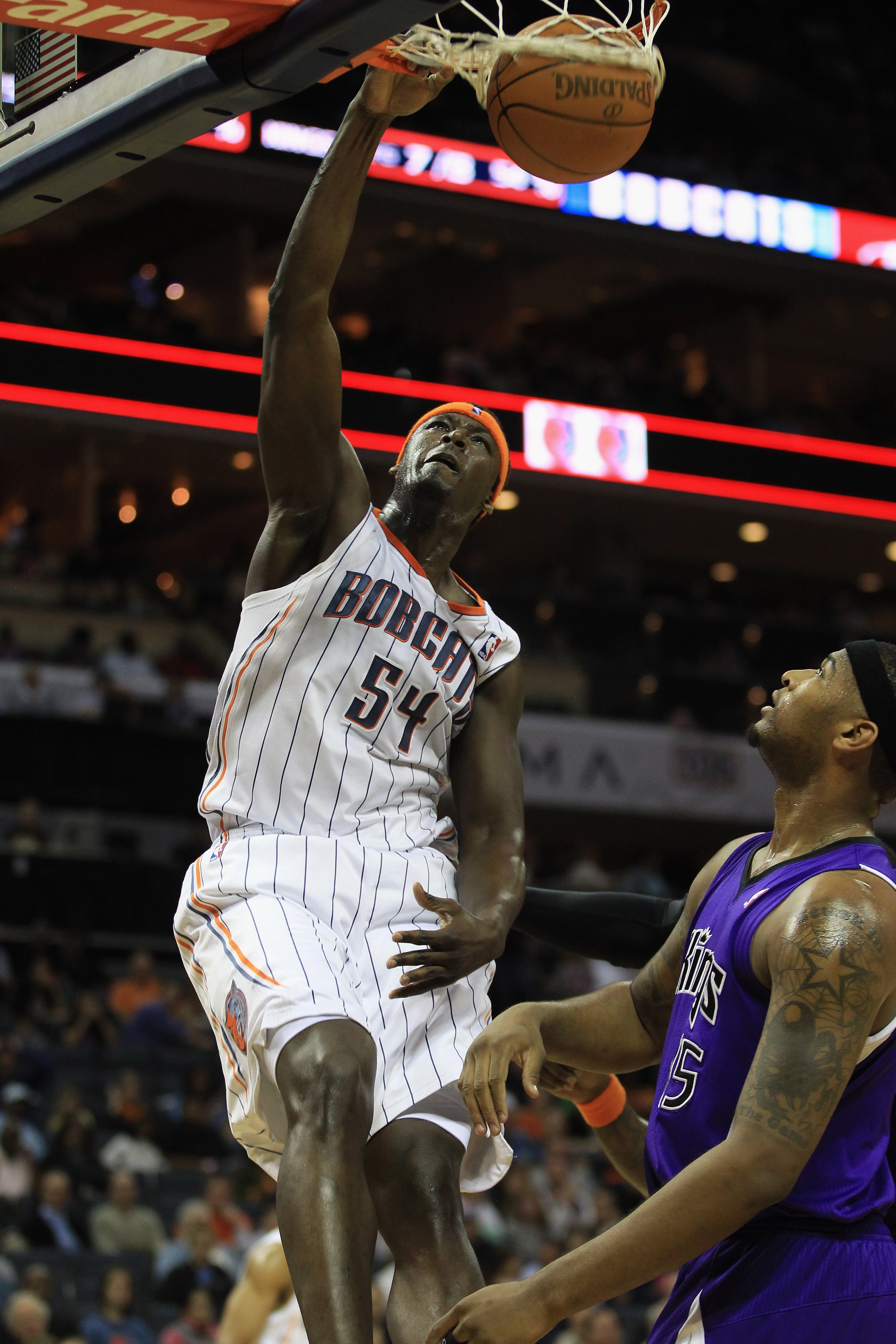 CHARLOTTE, NC - FEBRUARY 25:  DeMarcus Cousins #15 of the Sacramento Kings watches as Kwame Brown #54 of the Charlotte Bobcats dunks the ball during their game at Time Warner Cable Arena on February 25, 2011 in Charlotte, North Carolina. NOTE TO USER: Use